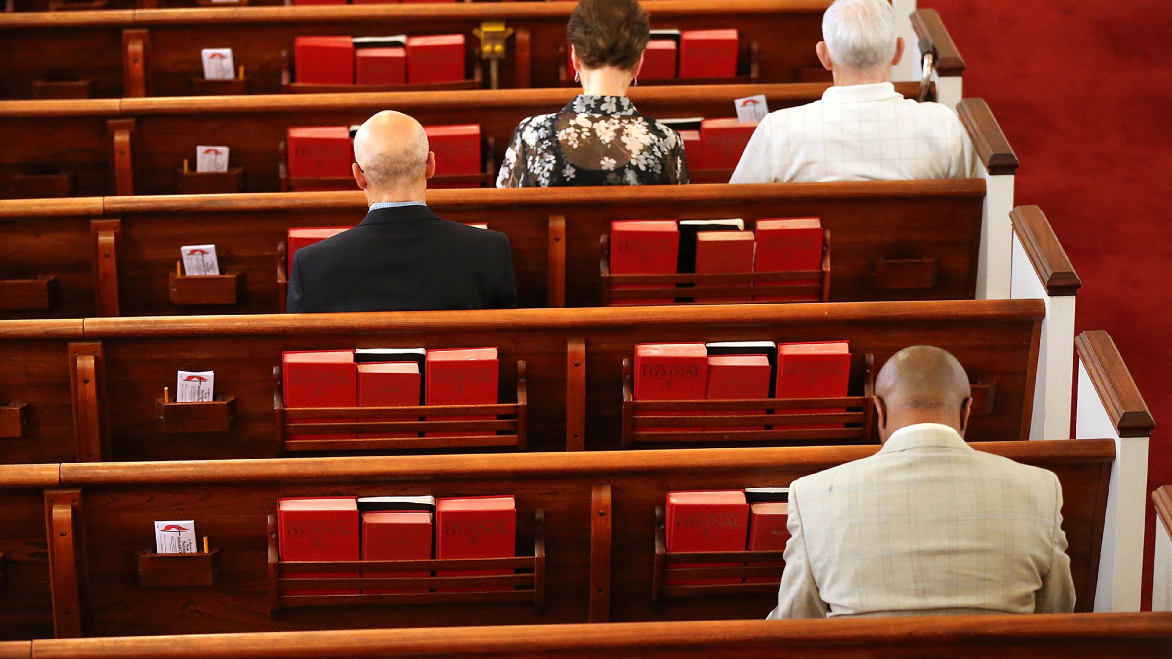Members bow their heads for the opening prayer at Clarkston United Methodist Church on Sunday, Sept. 18, 2016. Curtis Compton / ccompton@ajc.com