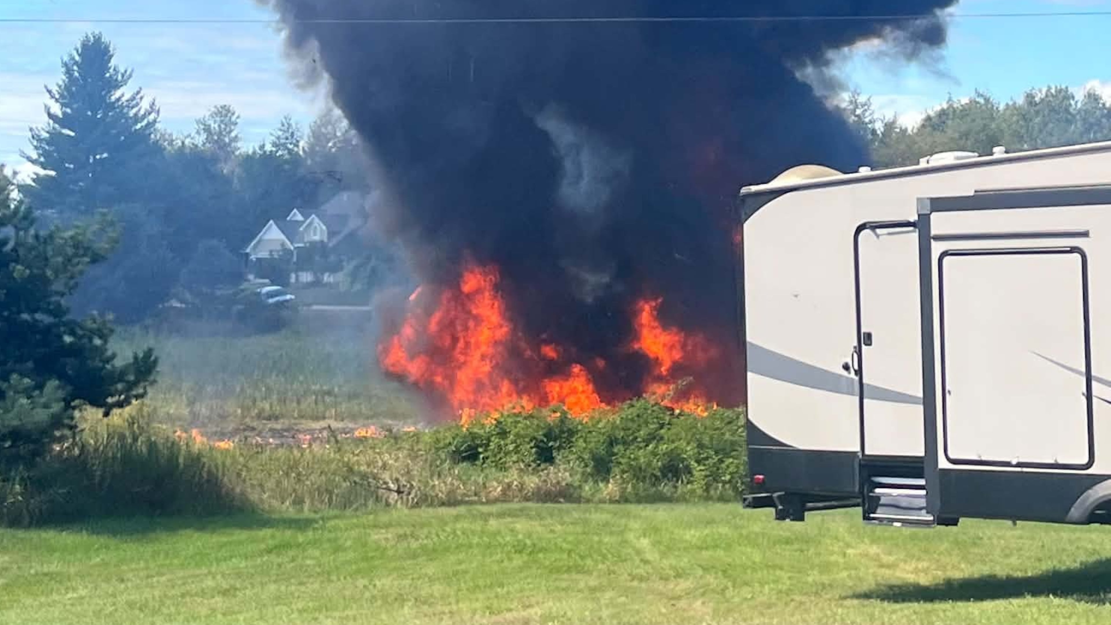 Smoke rises after an F-16 fighter jet crashed in a rural area near Traverse City, Mich., Thursday, Sept. 17, 2026. (Rebecca Lamberson via AP)