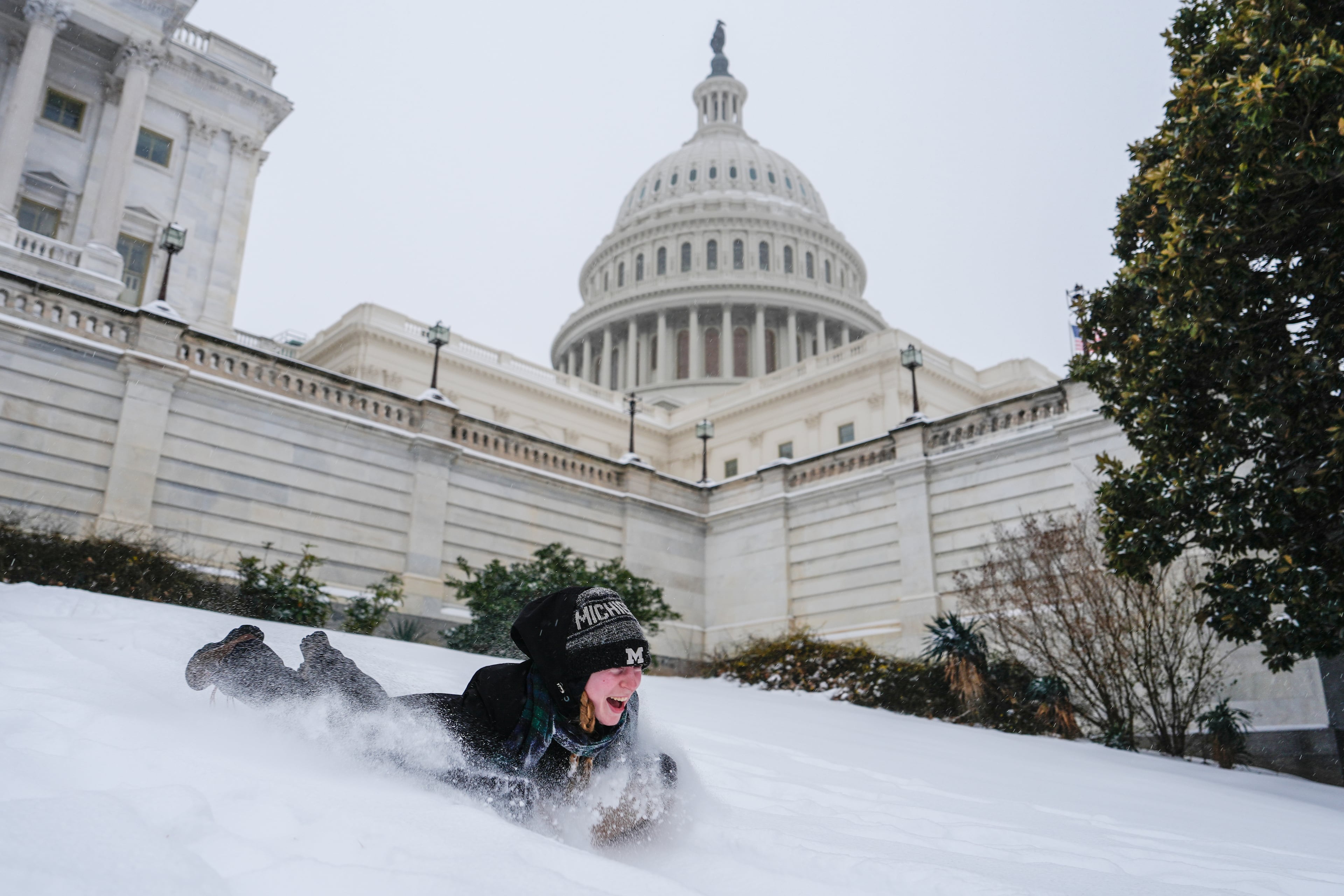 Emilia O'Brien of Michigan enjoyed the snow outside of the U.S. Capitol on Sunday. ( Julia Demaree Nikhinson/AP)