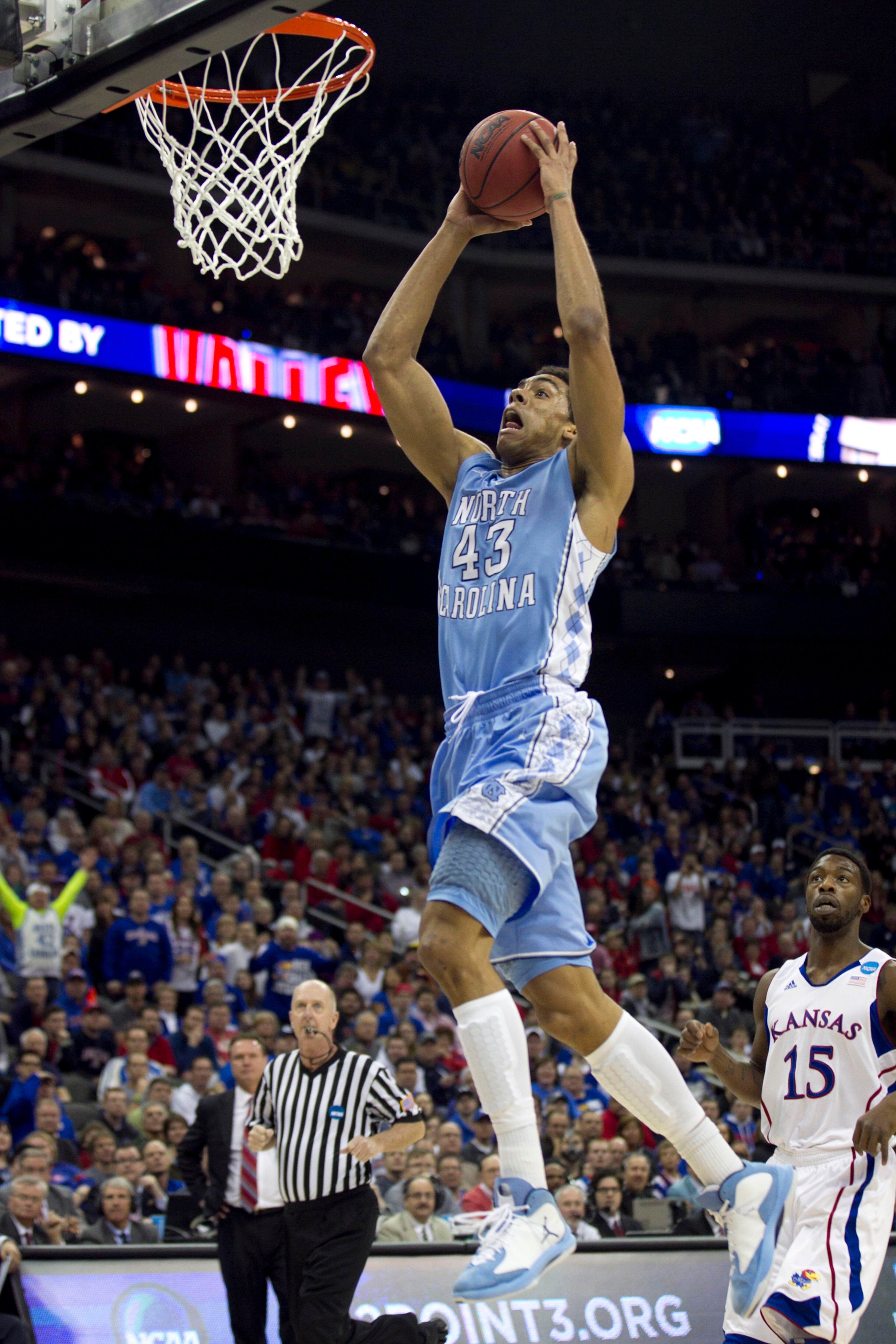 North Carolina's James Michael McAdoo (43) drives to the basket for a dunk past Kansas' Elijah Johnson (15) in the first half of a third-round game in the NCAA Tournament at the Sprint Center in Kansas City, Missouri, Sunday, March 24, 2013. (Robert Willett/Raleigh News & Observer/MCT)