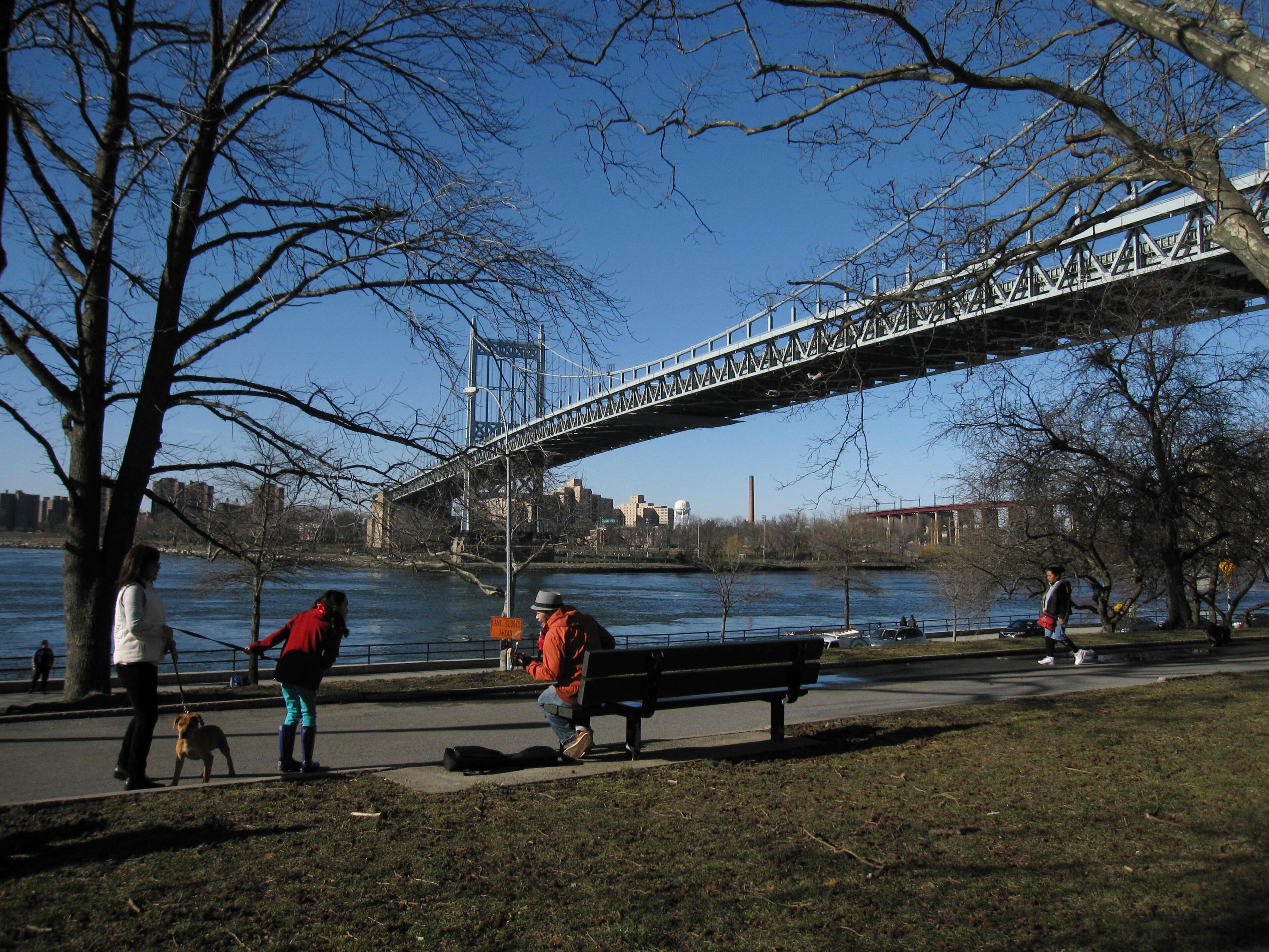 This March 9, 2013 photo shows visitors at Astoria Park in the New York City borough of Queens. It's one of several waterfront parks in Astoria and the adjacent neighborhood of Long Island City. The area also offers museums, a variety of ethnic restaurants and moderately priced hotels with easy access to Manhattan. The photo also shows the Triborough Bridge connecting Queens with the Bronx across the water.