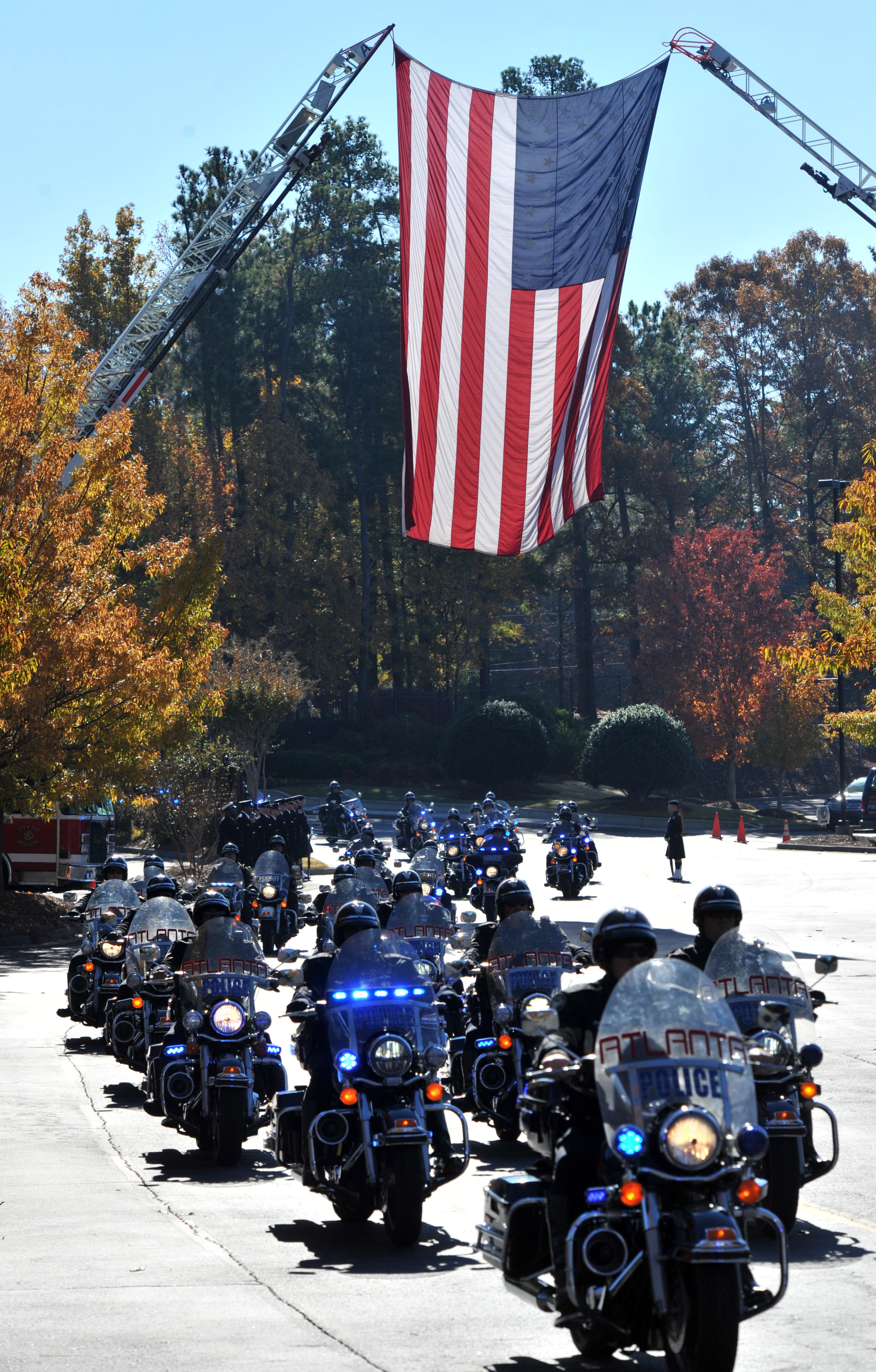 The motorcade pulls into the church for APD Officer Shawn Smiley's funeral at First Baptist Church of Atlanta on Saturday, November 10, 2012. APD Officer Shawn Smiley was in the passenger seat last weekend when an APD helicopter searching for a missing 9-year-old boy crashed in Atlanta. HYOSUB SHIN / HSHIN@AJC.COM