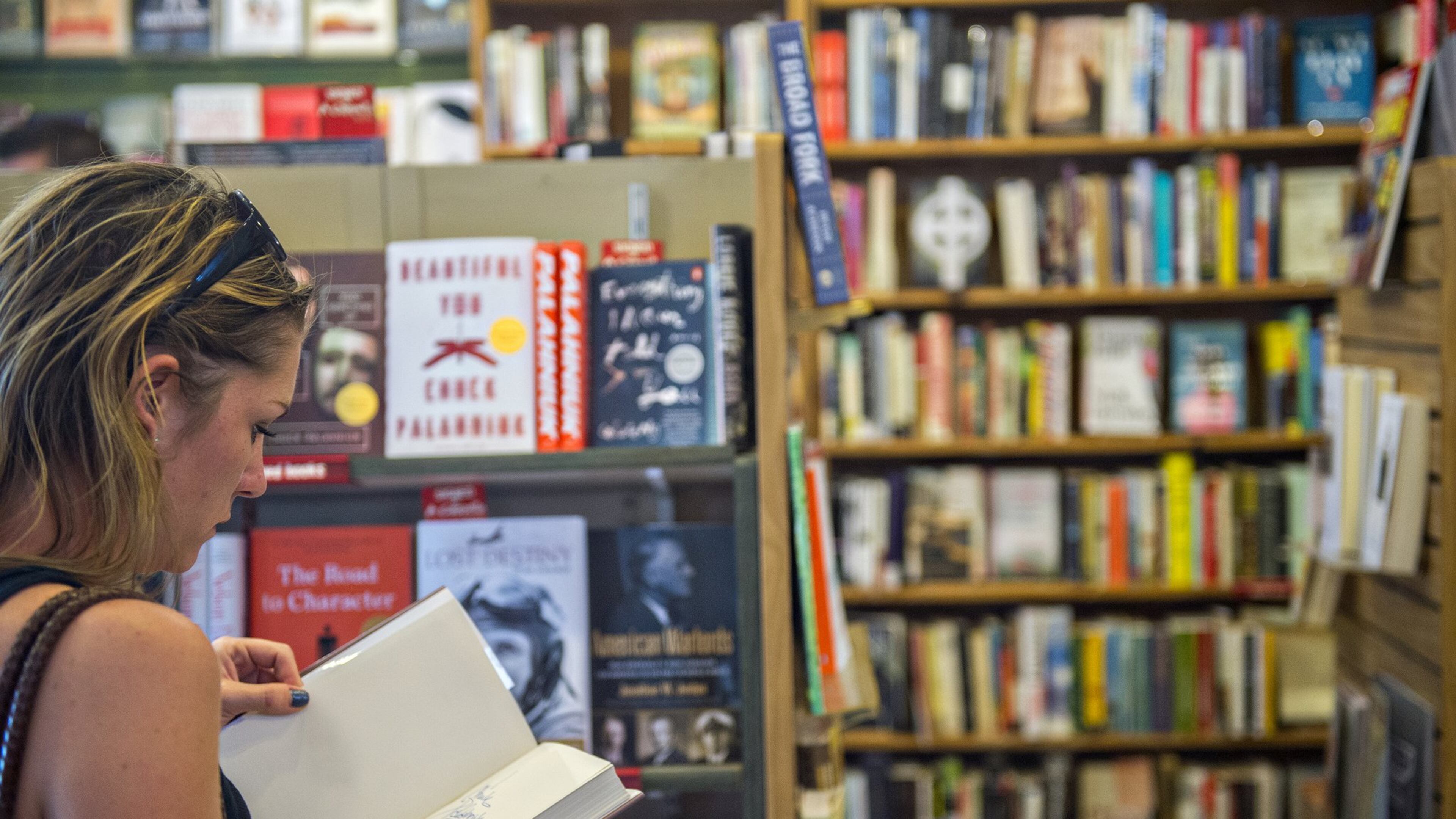 Katie Ellis thumbs through a book at A Cappella bookstore in Atlanta, a local staple for decades. An estimated 15,000 self-help books are published each year in the U.S. The challenge is finding a self-help strategy that fits. (Jonathan Phillips for The Atlanta Journal-Constitution)