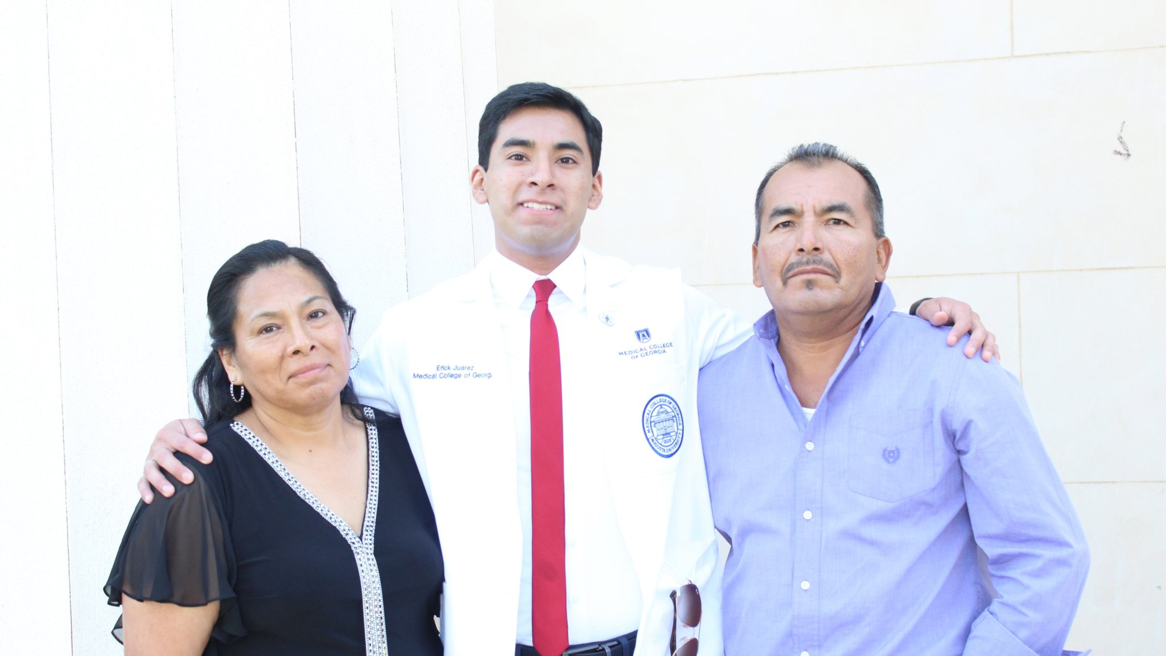 Erick Martinez Juarez with his parents Loreto and Maricela Juarez at his medical-school white coat ceremony.