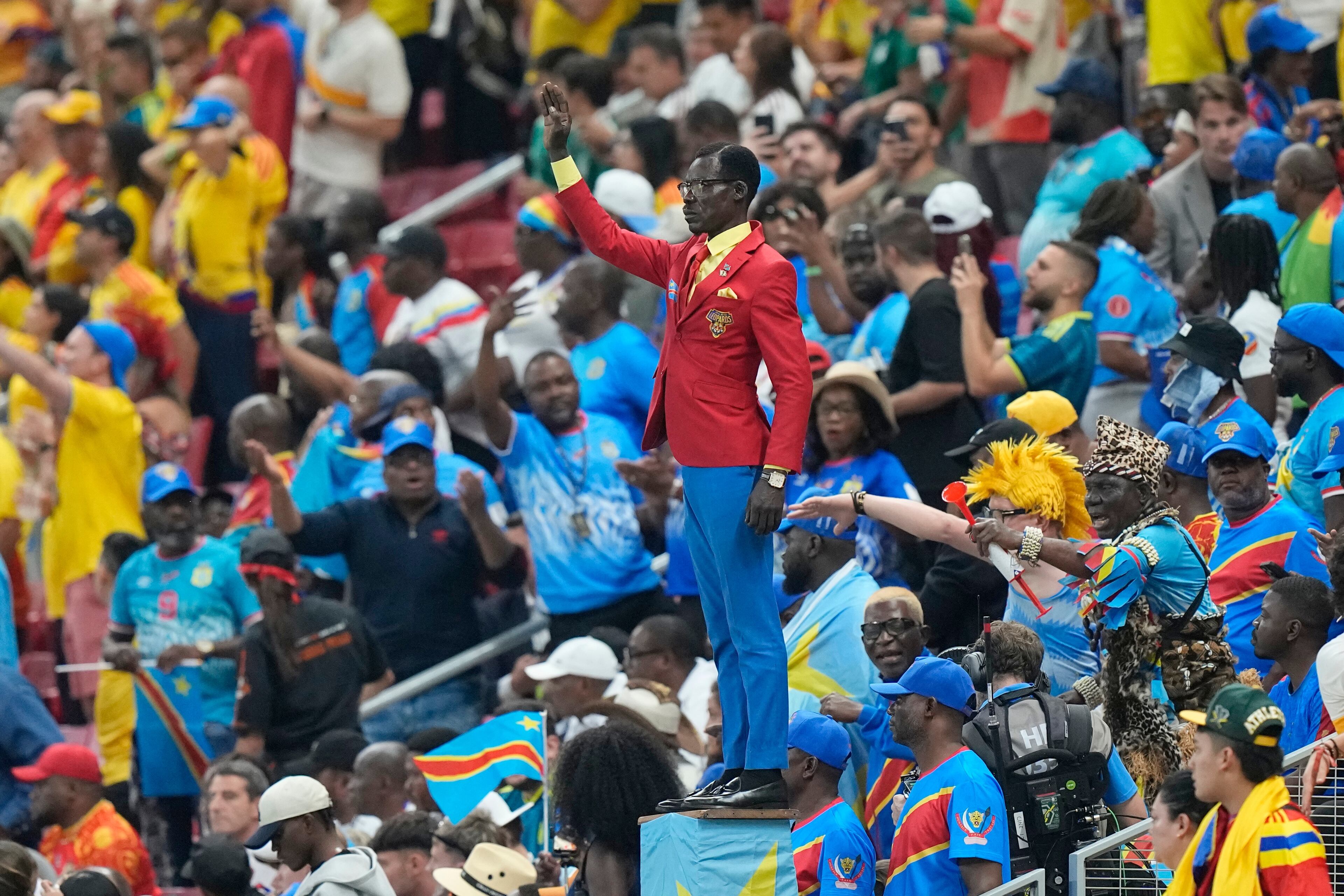 Congo supporter Michel Nkuka Mboladinga poses as a statue of the country’s assassinated independence hero Patrice Lumumba ahead of the group stage match between Colombia and Congo in Mexico. (Fernando Llano/AP)