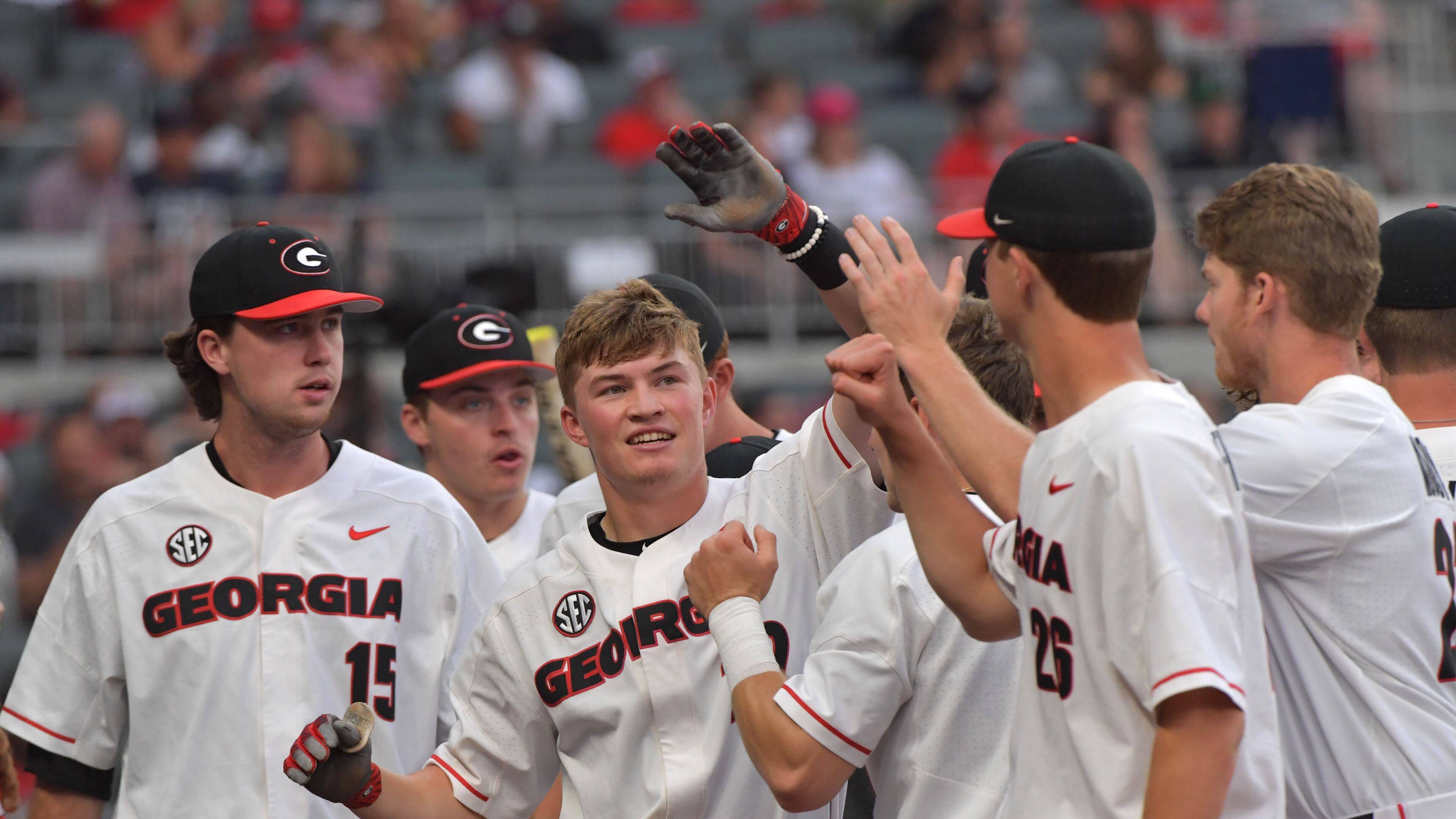 Georgia’s Aaron Schunk (22) is congratulated by teammates after he hit a home run against Georgia Tech at SunTrust Park on Tuesday, May 8, 2018. HYOSUB SHIN / HSHIN@AJC.COM