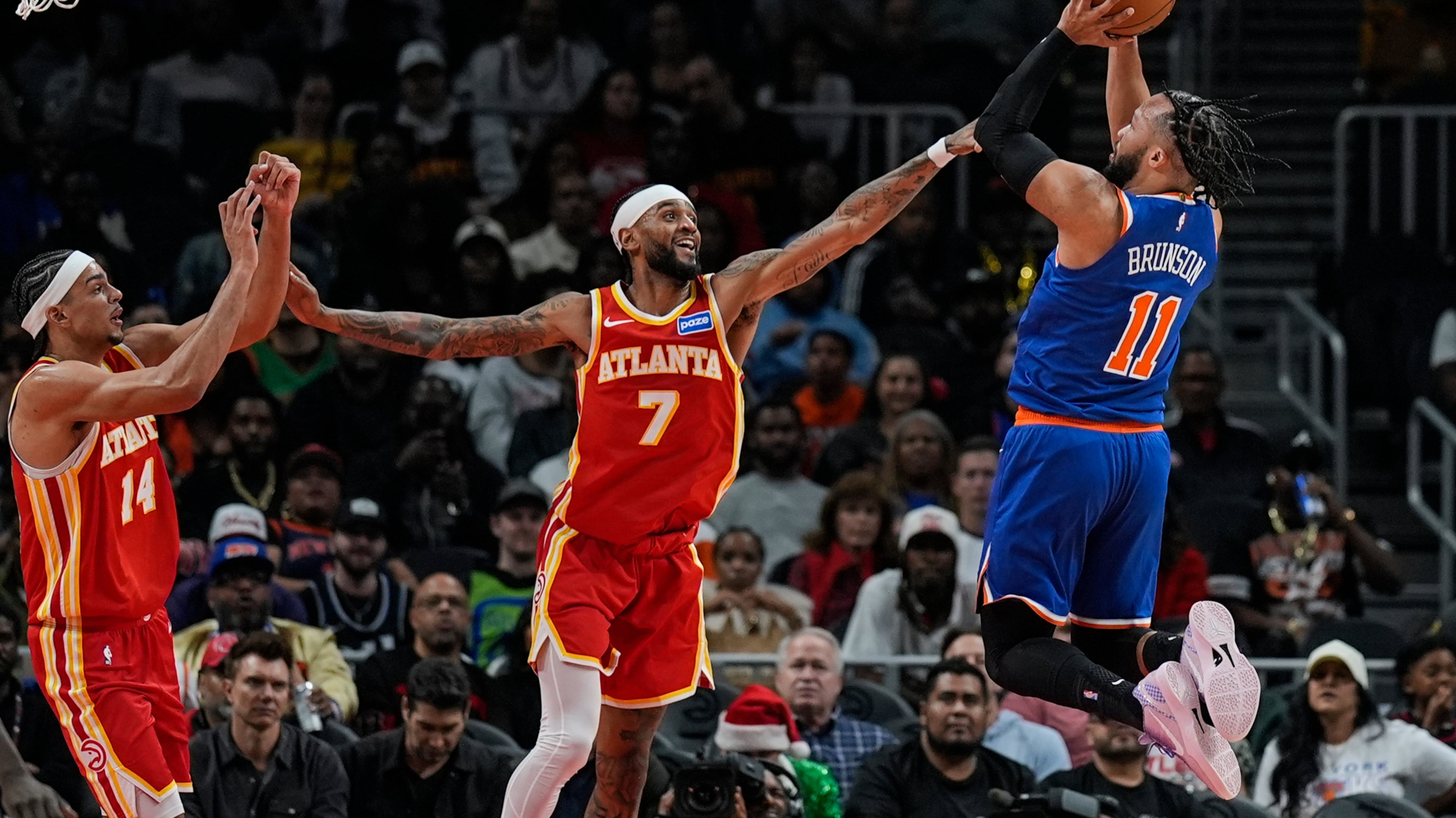 New York Knicks guard Jalen Brunson (11) shoots against Atlanta Hawks guard Nickeil Alexander-Walker (7) during the first half of an NBA basketball game, Saturday, Dec. 27, 2025, in Atlanta. (AP Photo/Mike Stewart)