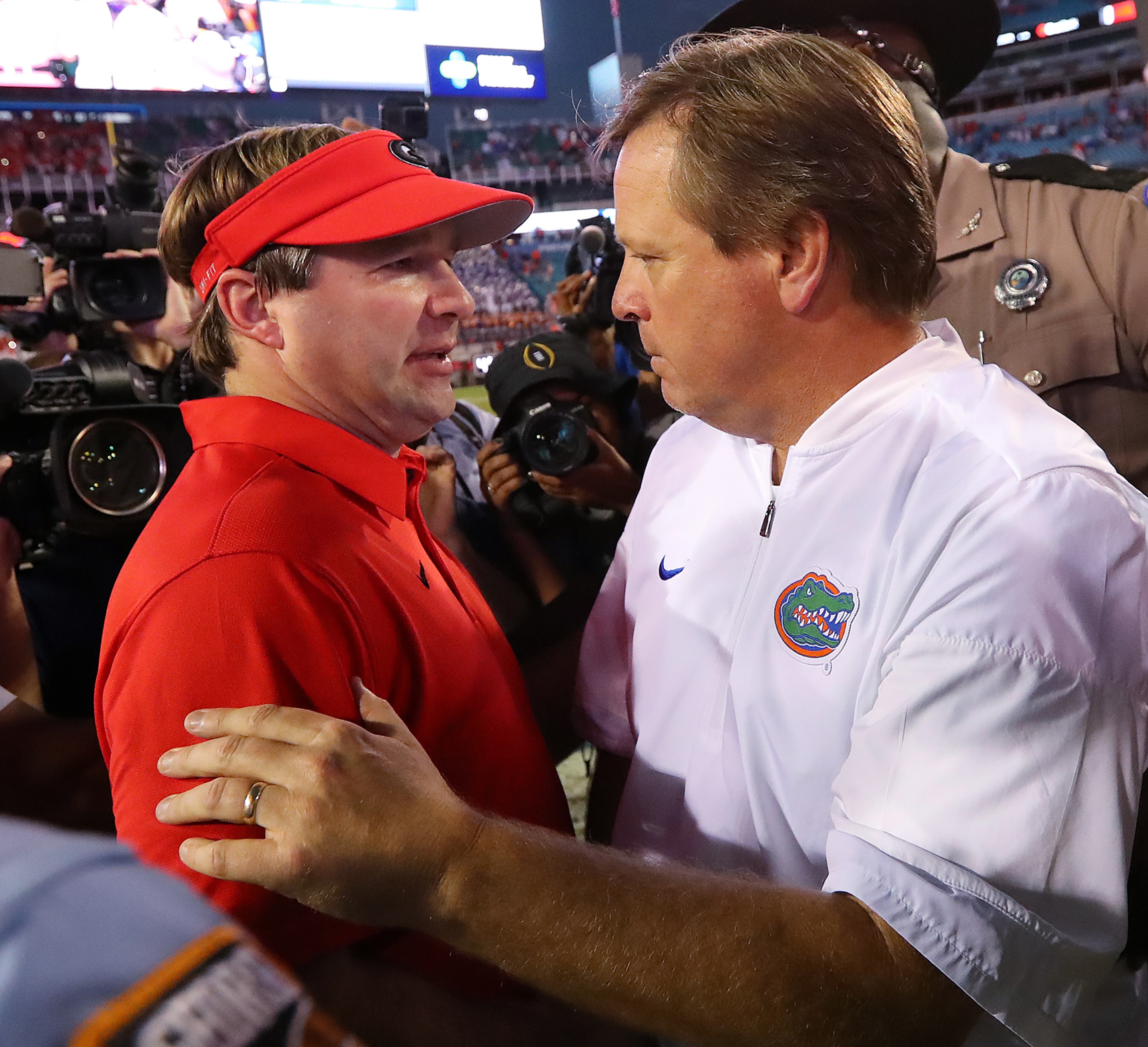 October 28, 2017 Jacksonville: Georgia head coach Kirby Smart and Florida head coach Jim McElwain meet at midfield after Georgia beat Florida 42-7 in a NCAA college football game on Friday, October 27, 2017, in Jacksonville. Curtis Compton/ccompton@ajc.com