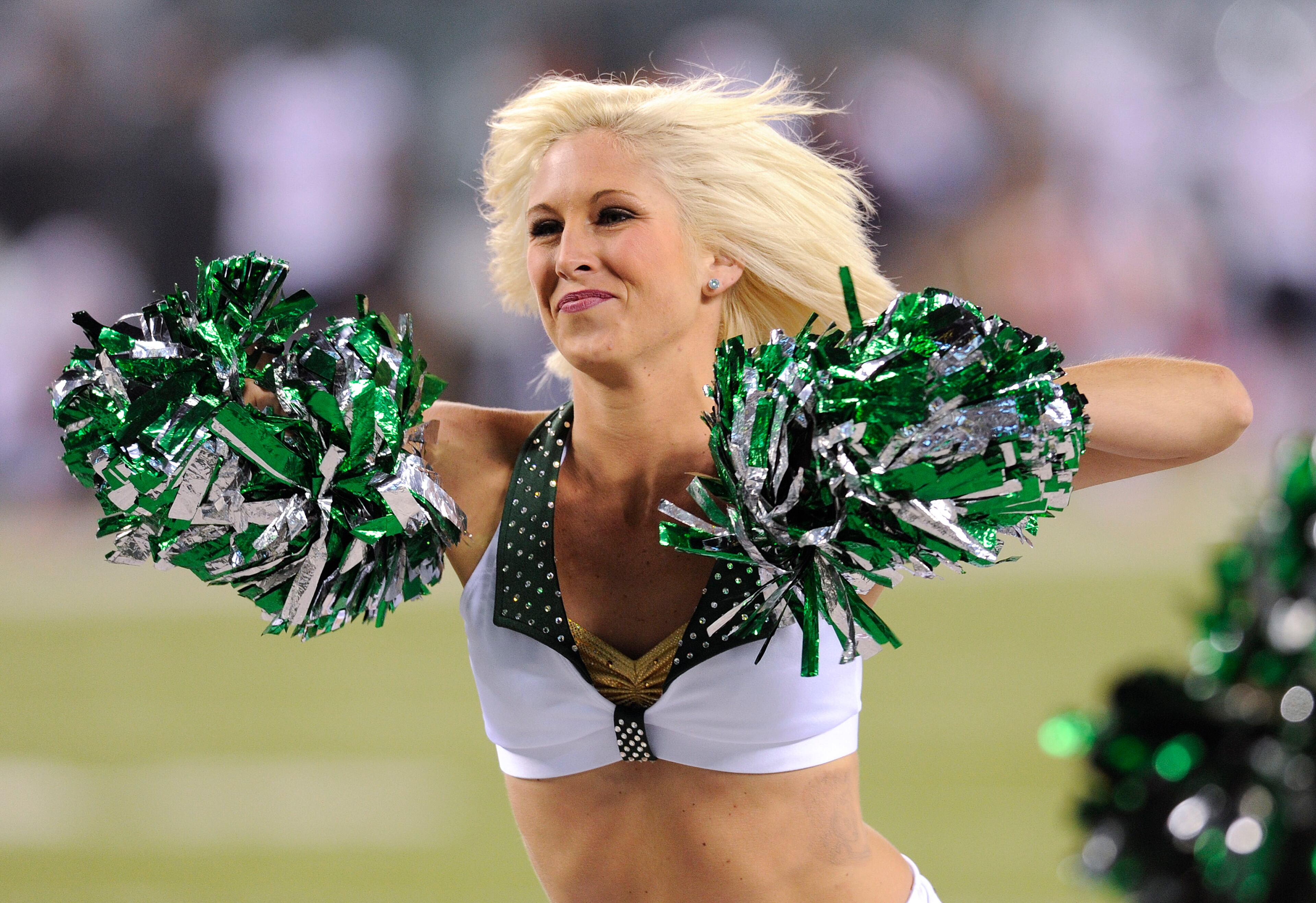 A New York Jets cheerleader performs on the sidelines against the Chicago Bears during the fourth quarter of an NFL football game, Monday, Sept. 22, 2014, in East Rutherford, N.J. (AP Photo/Bill Kostroun)
