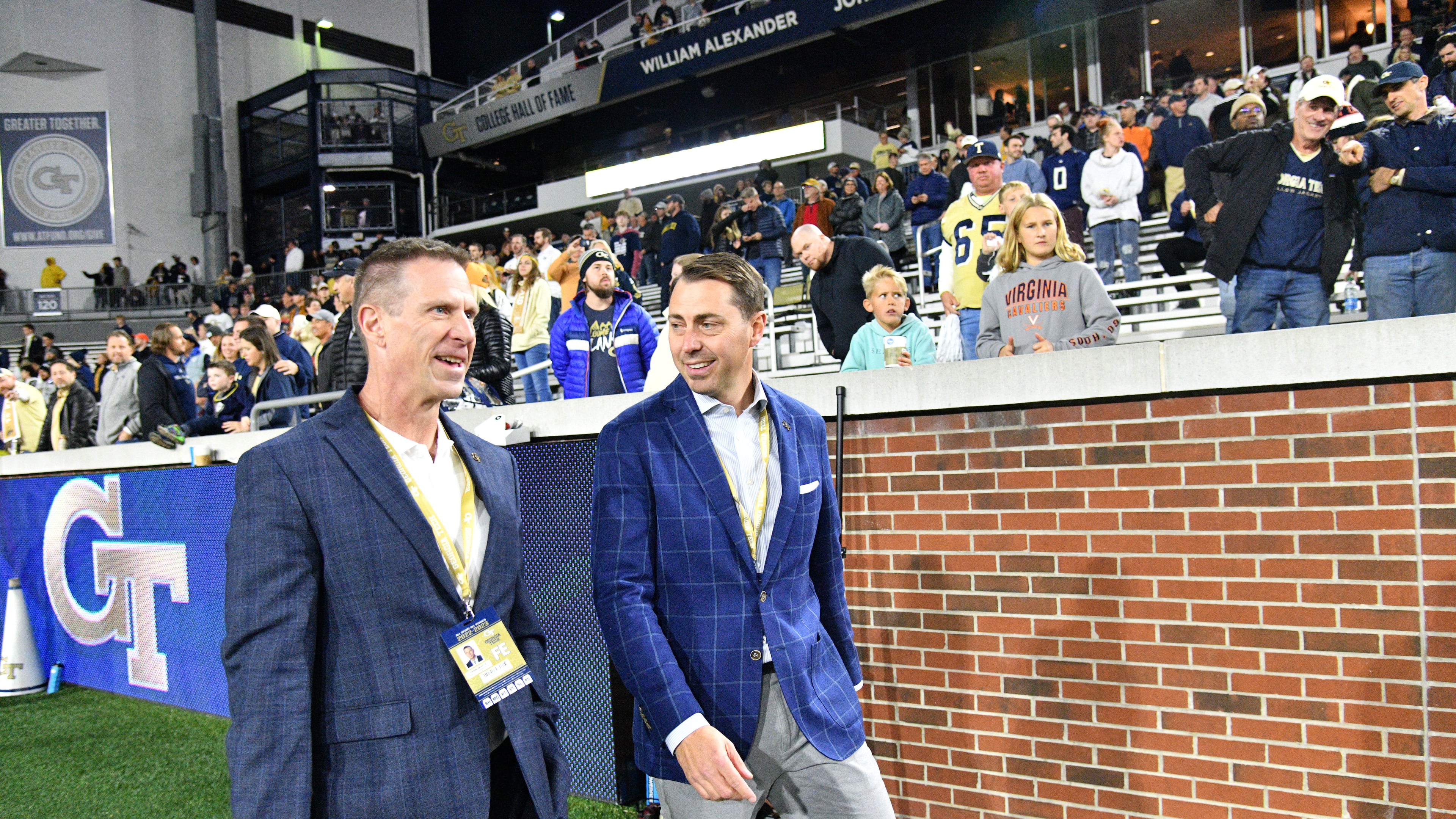Incoming athletic director J Batt (right) talks with interim athletic director Frank Neville before their game against Virginia at Georgia Tech's Bobby Dodd Stadium in Atlanta on Thursday, October 20, 2022. (Hyosub Shin / Hyosub.Shin@ajc.com)