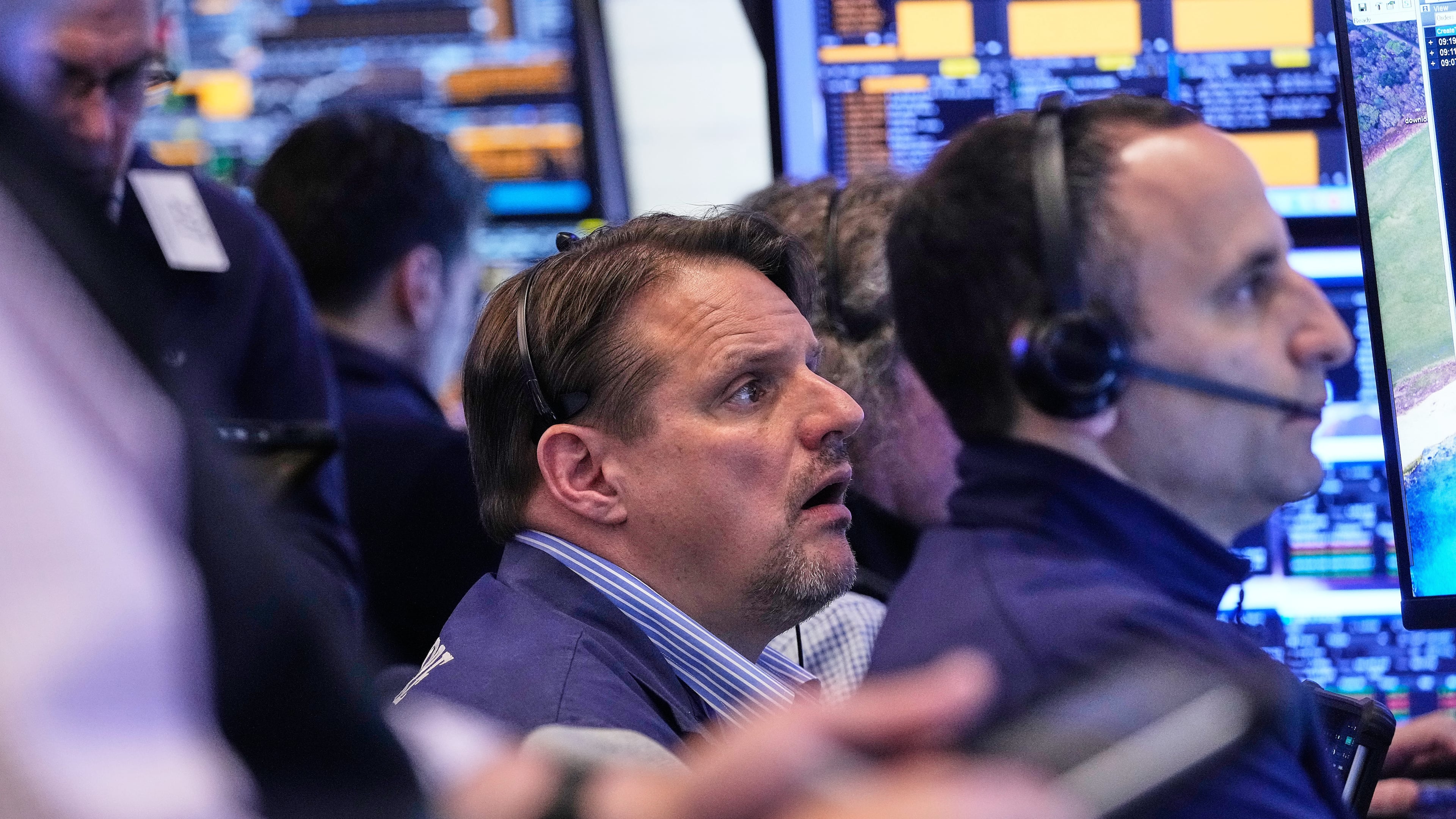 Trader Michael Milano, center, works with colleagues on the floor of the New York Stock Exchange, Wednesday, May 13, 2026. (AP Photo/Richard Drew)