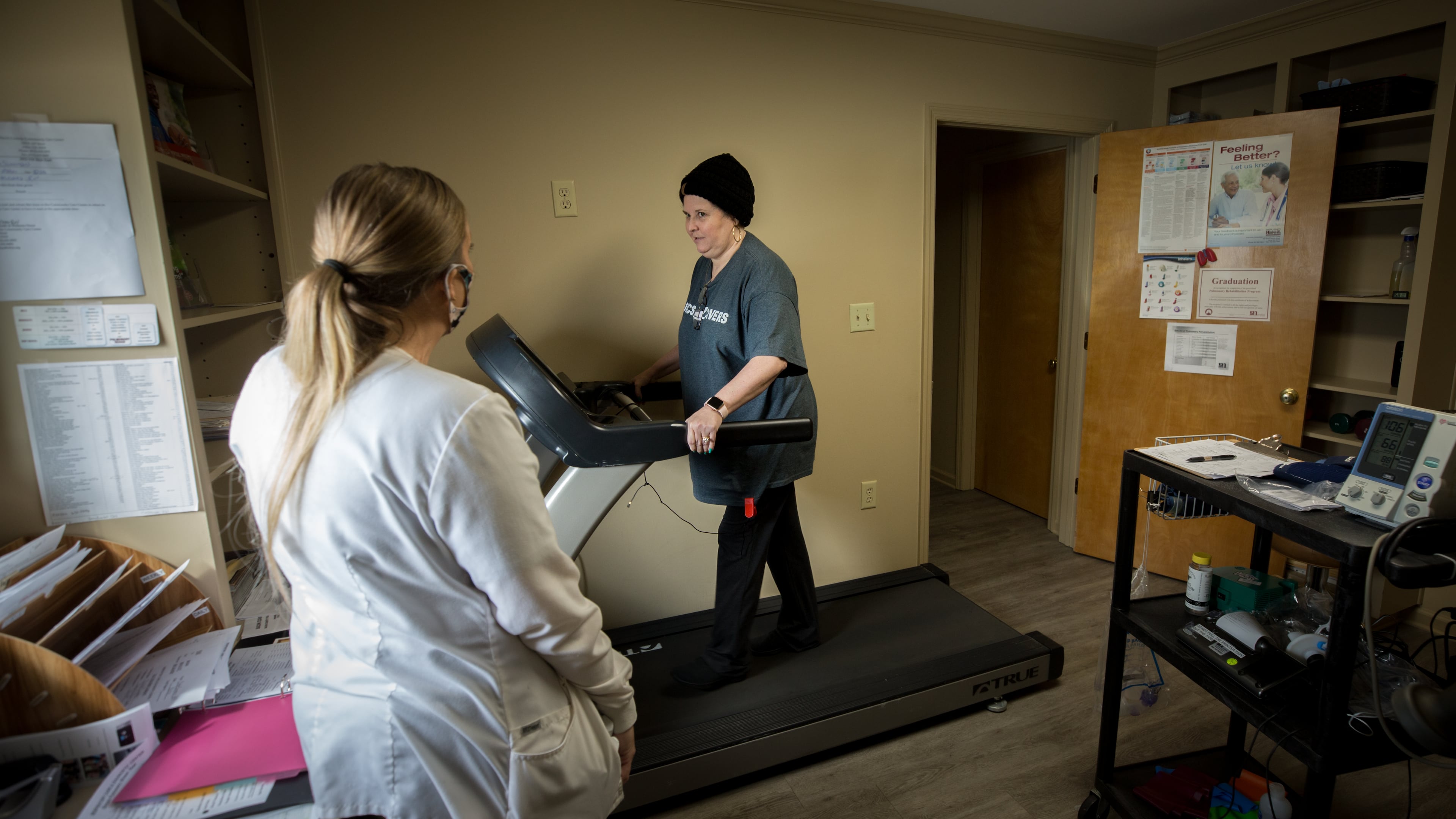 Overcoming the lung damage caused by COVID-19 starts with short steps on a treadmill for Lisa Martin under the watchful eye of Christie Simmons, pulmonary rehabilitation director for Bacon County Hospital. (AJC Photo/Stephen B. Morton)