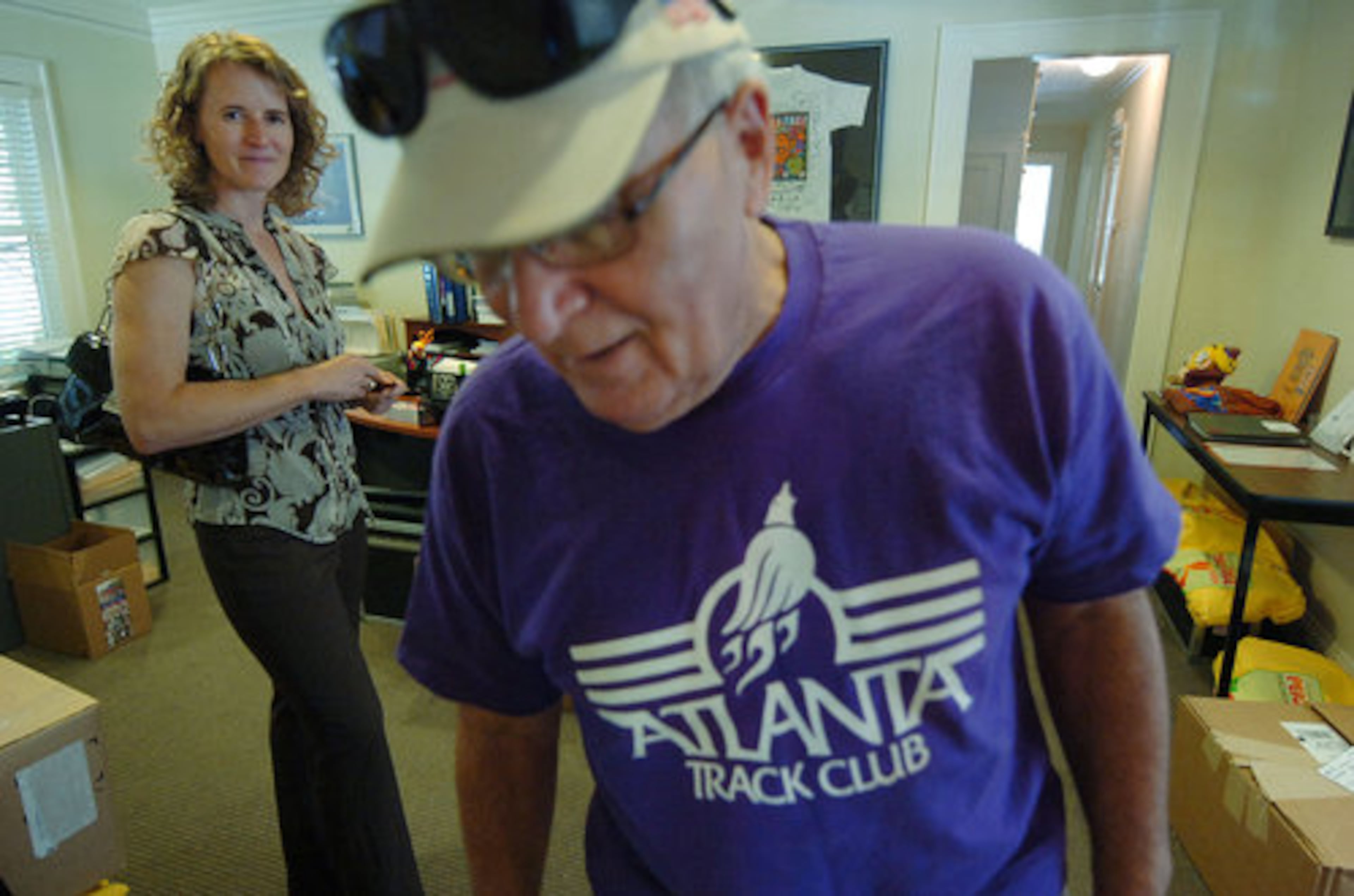 Russell (left) prepares to head to lunch with longtime track club volunteer Nick Discenza (right). Five years from now Russell said she wants "to get past the image that the Atlanta Track Club is for the elite runners. ... We're really going to work on some programs that are geared toward that first-time runner. That person who runs Peachtree. That person who runs three days per year. We want as the ATC to have a greater impact on the community's health and wellness."