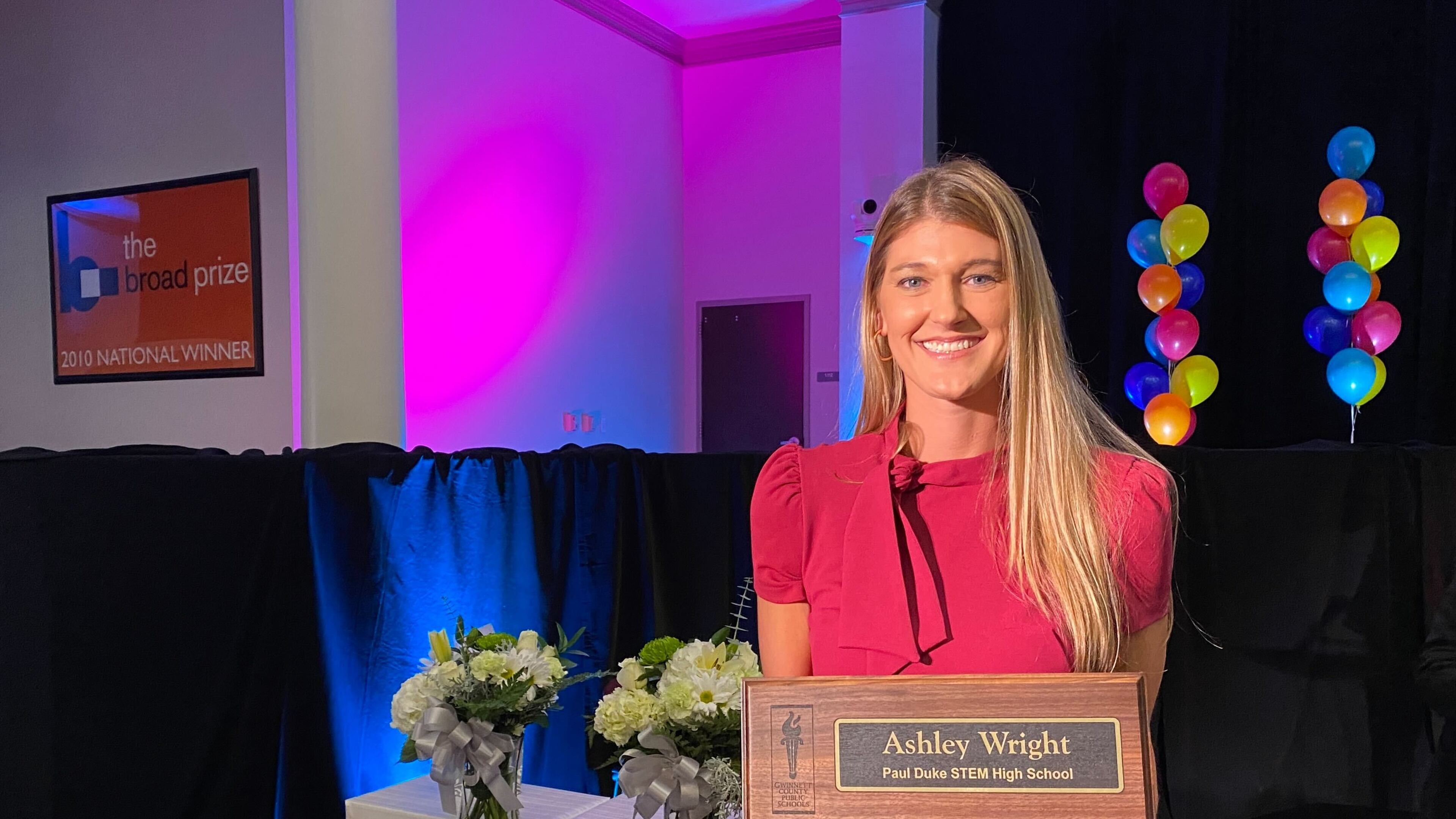 Ashley Wright, a graphic design teacher at Paul Duke STEM High School, poses with her award for being named teacher of the year in Gwinnett County Public Schools.