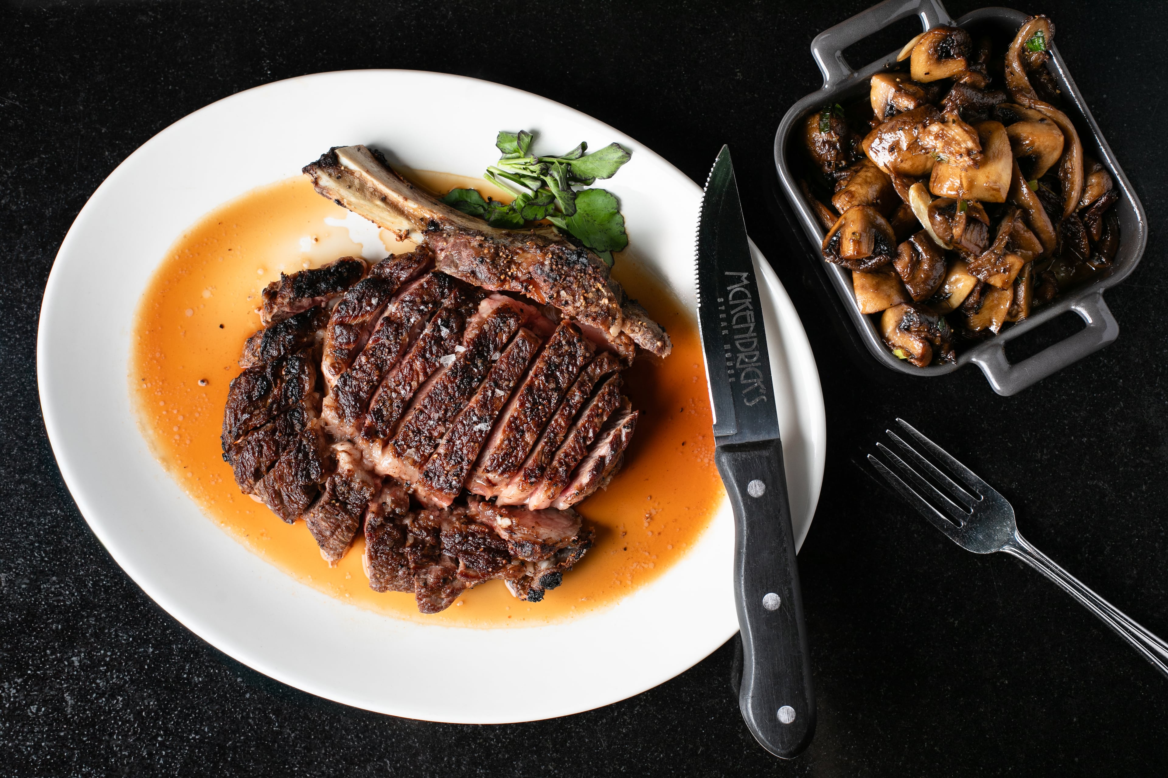 The crowning steak on the McKendrick's menu is a 30-ounce, 30-day dry-aged tomahawk rib-eye. (Erik Meadows Photography/Courtesy of McKendrick's Steakhouse & Bar)