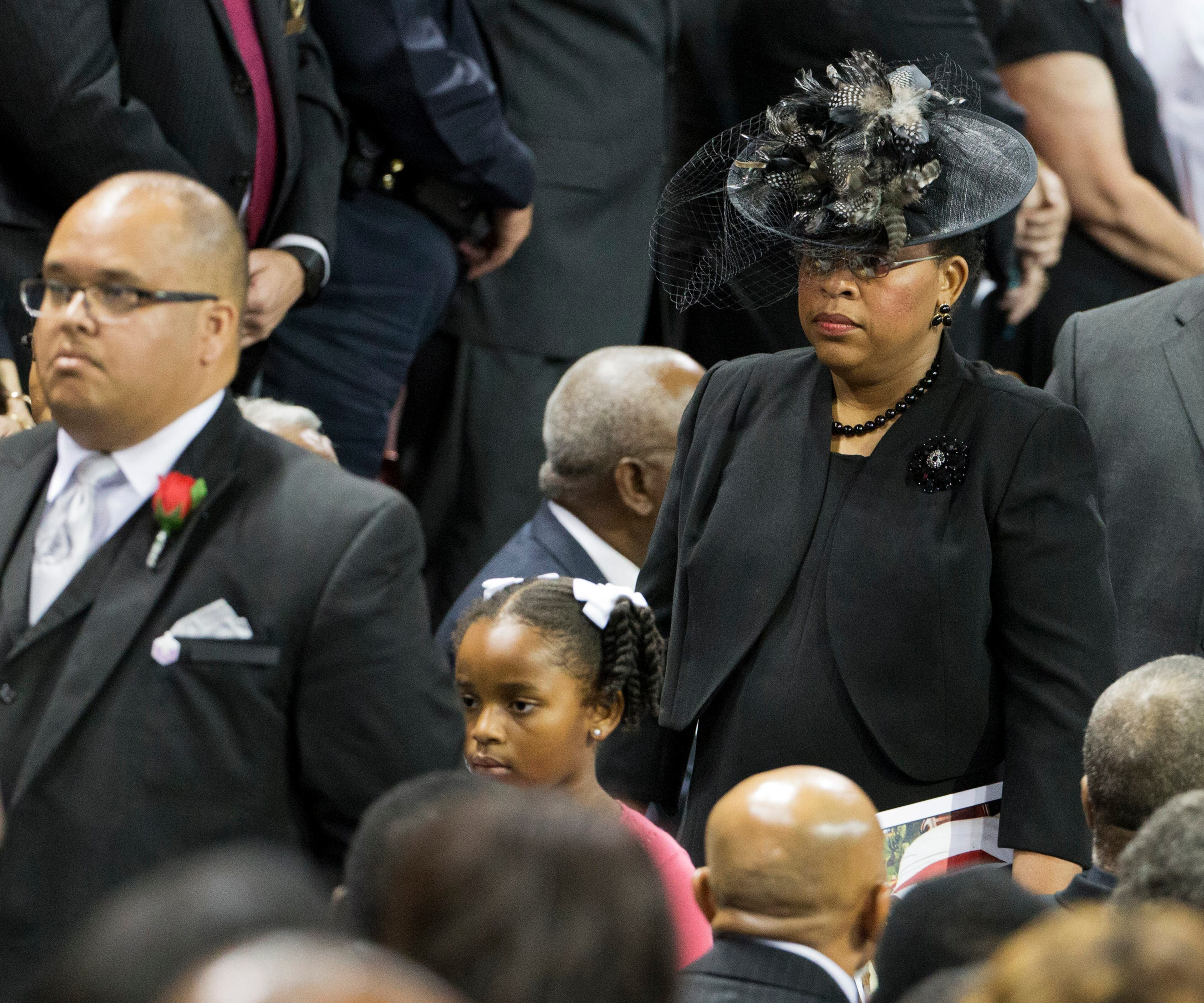 Sen. Clementa Pinckney's wife Jennifer Pinckney, right, and daughter Malana walk in for his funeral service, Friday, June 26, 2015, in Charleston, S.C. President Barack Obama will deliver the eulogy at Pinckney's funeral Friday at College of Charleston's TD Arena near the Emanuel AME Church, the scene of last week's shooting. (AP Photo/David Goldman)