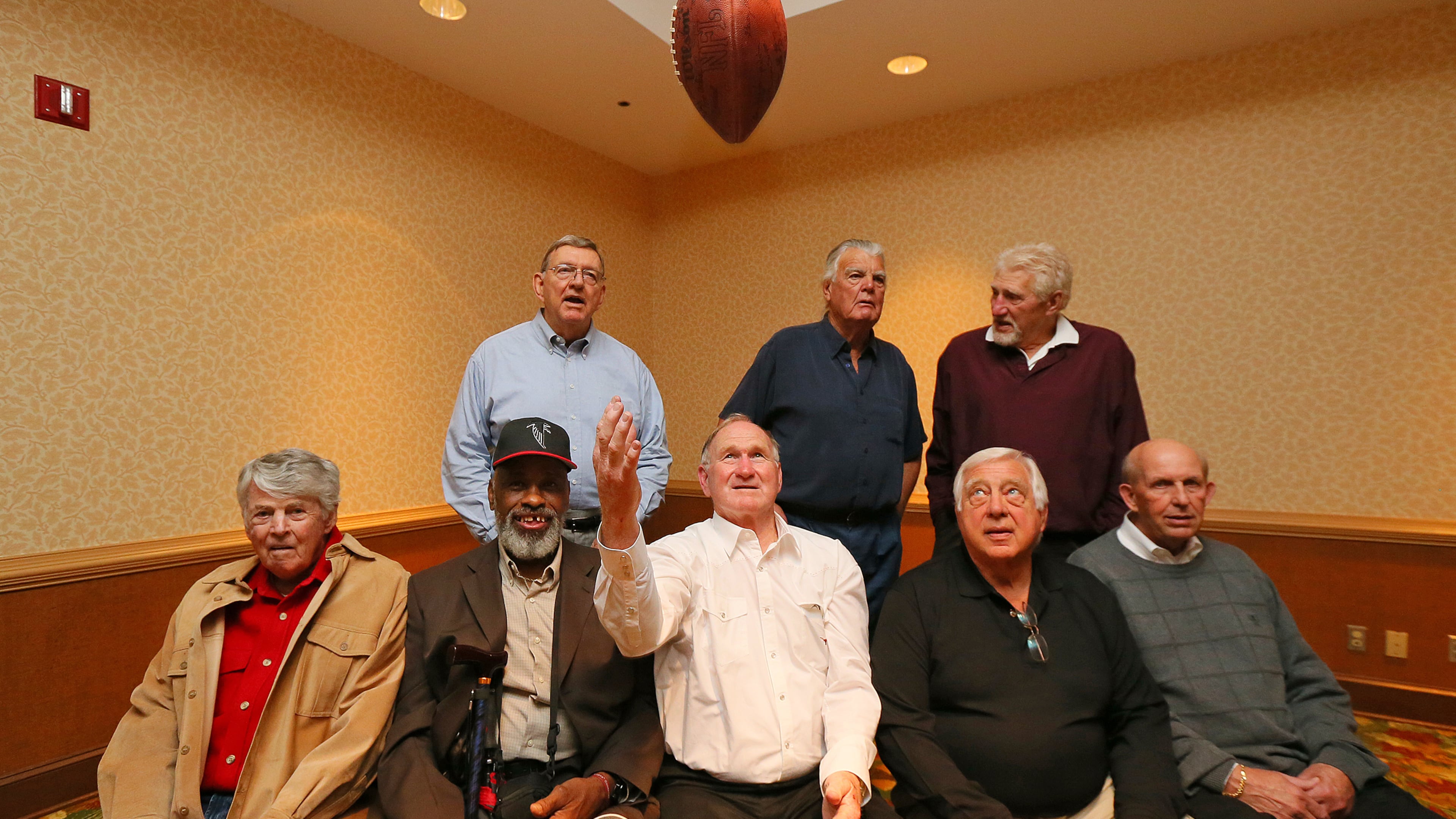 Players from the 1966 Falcons team gather during a reunion around the Falcons first-ever draft pick Tommy Nobis tossing a football in the air on Saturday, May 4, 2013, at Lake Lanier Islands Resort. Front (from left) are general manager Tom Braatz, defensive back Ken Reaves, linebacker Tommy Nobis, linebacker Ralph Heck, and wide receiver Gary Barnes. Back row (from left) are kicker Lou Kirovac, tackle Don Talbert, and tight end Bill Martin. CURTIS COMPTON / CCOMPTON@AJC.COM