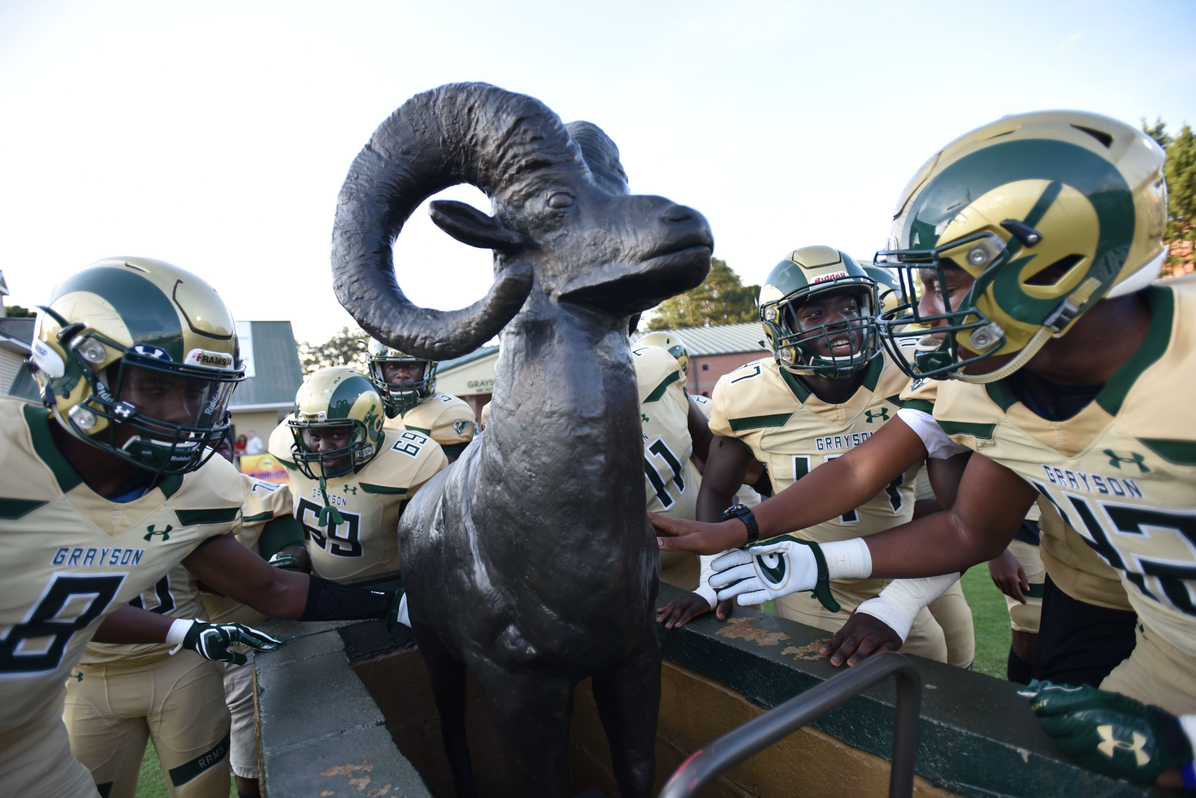 Grayson football players touch their ram status before their game against the Hoover (Alabama) at Grayson High School in Loganville on Friday, August 25, 2017. HYOSUB SHIN / HSHIN@AJC.COM