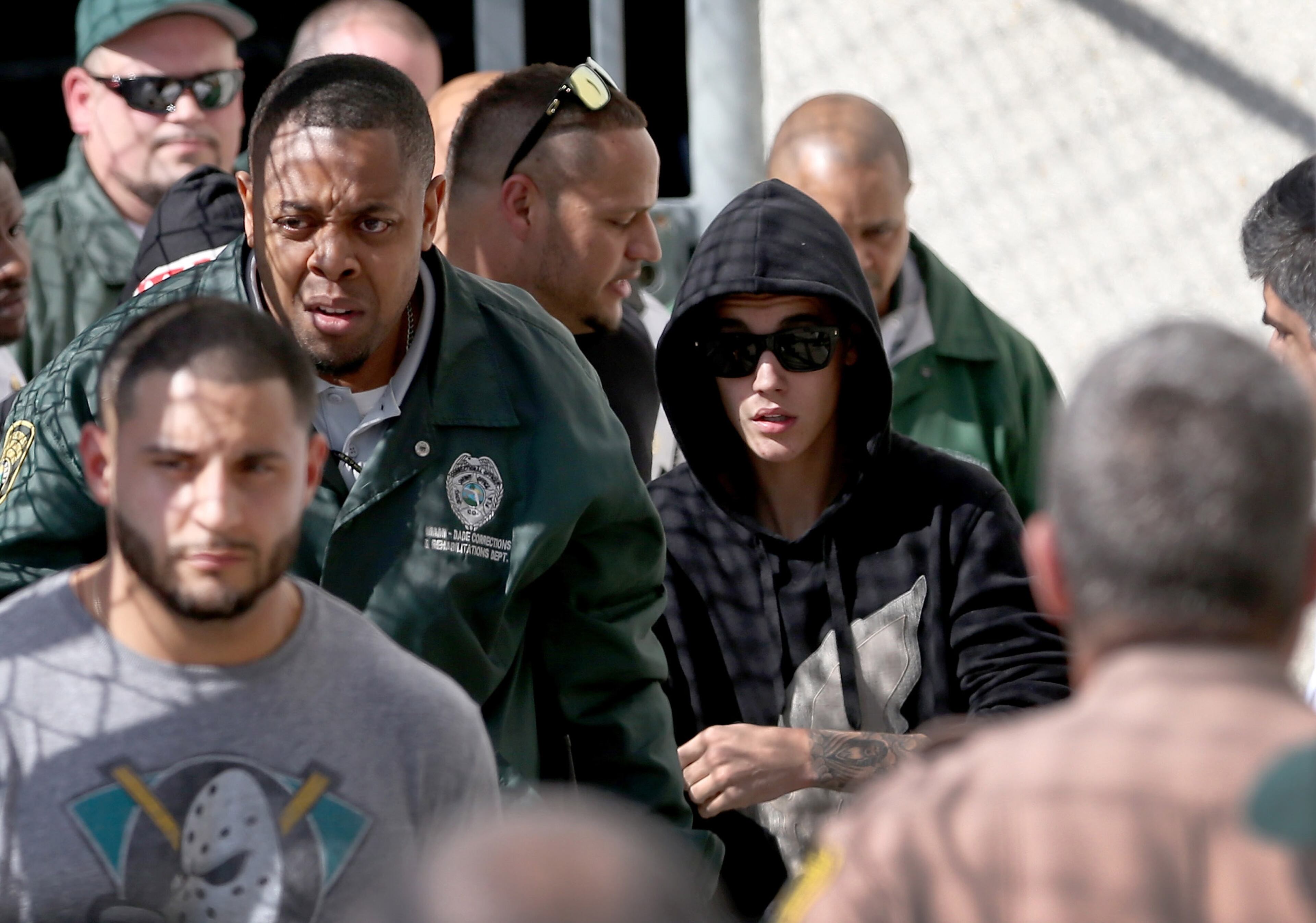 MIAMI, FL - JANUARY 23: Justin Bieber (R) exits from the Turner Guilford Knight Correctional Center on January 23, 2014 in Miami, Florida. Justin Bieber was charged with drunken driving, resisting arrest and driving without a valid license after Miami Beach police found the pop star street racing Thursday morning. (Photo by Joe Raedle/Getty Images)