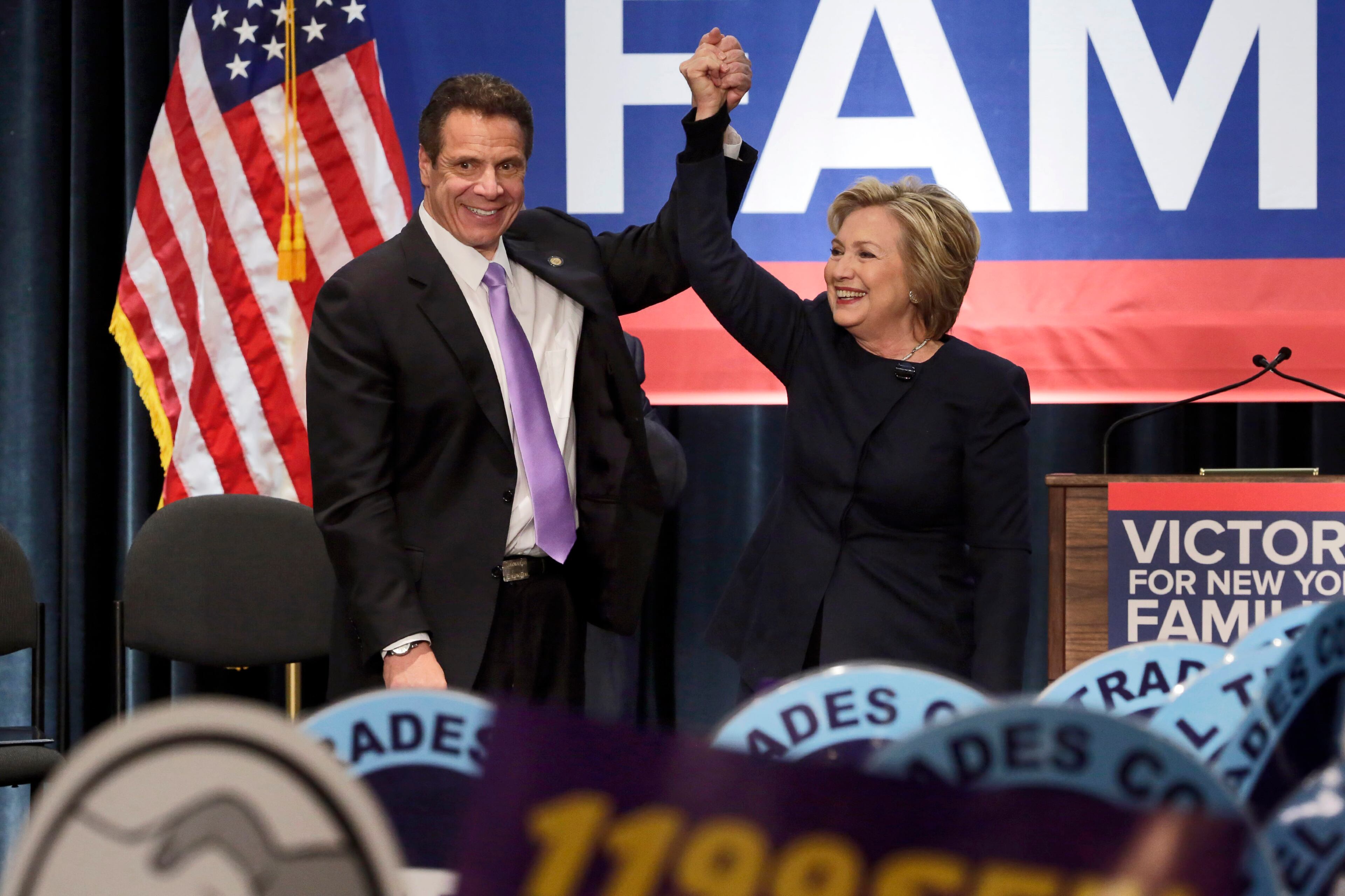 Democratic presidential candidate Hillary Clinton and New York Gov. Andrew Cuomo clasp hands during a rally at the Javits Convention Center, Monday, April 4, 2016 in New York. Cuomo signed a law that will gradually raise New York's minimum wage to $15. (AP Photo/Richard Drew)