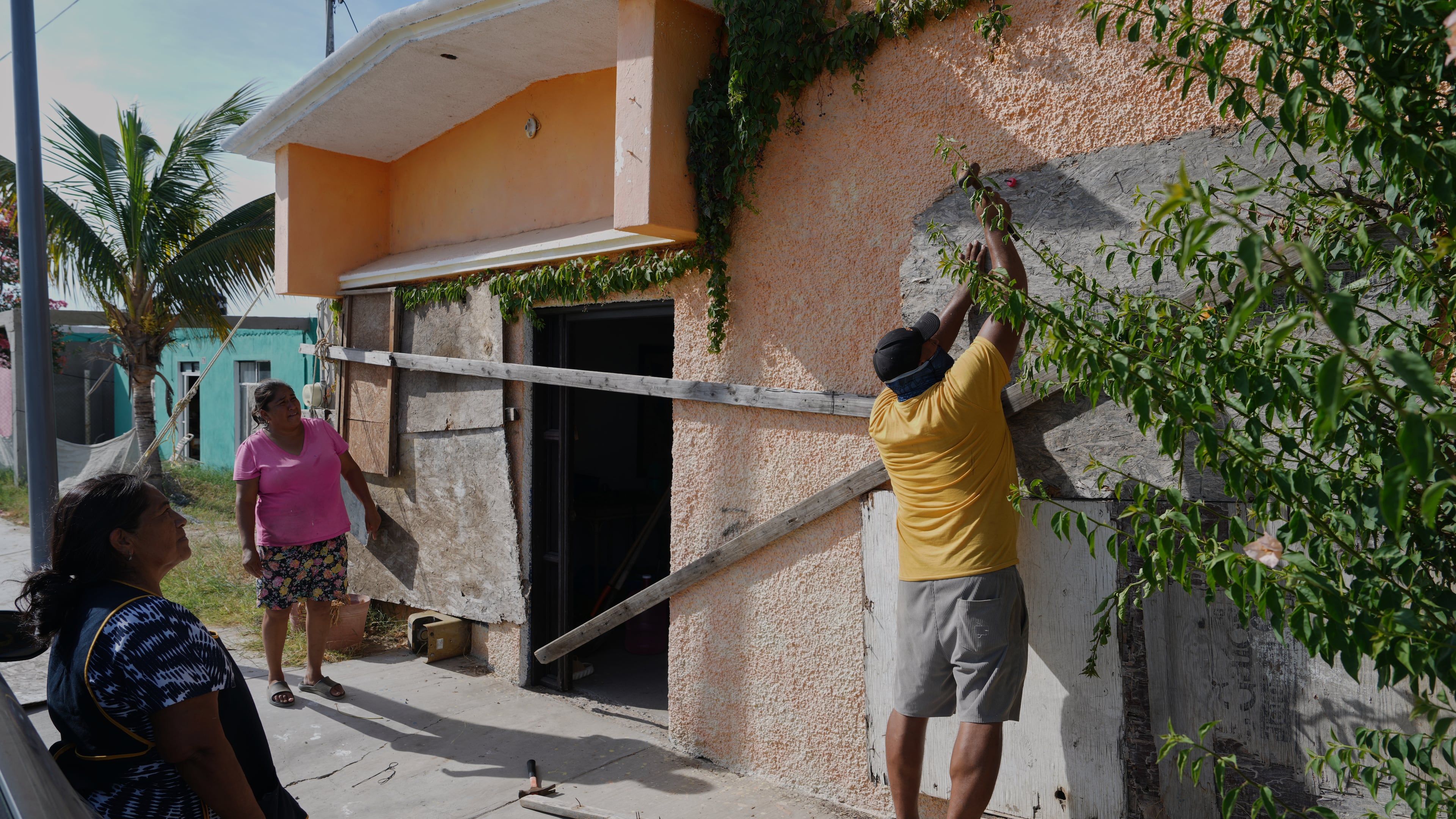 A man boards up a house's windows as Hurricane Polo approaches in Puerto San Carlos, Baja California Sur state, Mexico, Sunday, Sept. 27, 2026. (AP Photo/Eduardo Verdugo)