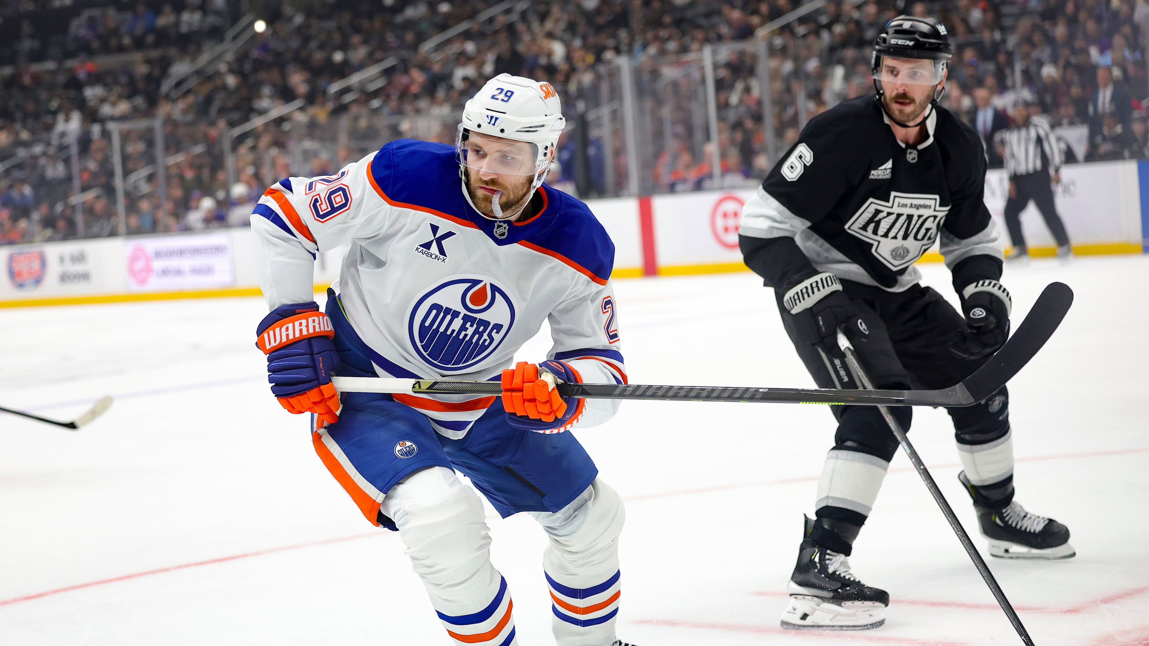 Edmonton Oilers center Leon Draisaitl, left, skates against Los Angeles Kings defenseman Joel Edmundson during the first period of an NHL hockey game Thursday, Feb. 26, 2026 in Los Angeles. (AP Photo/Ryan Sun)