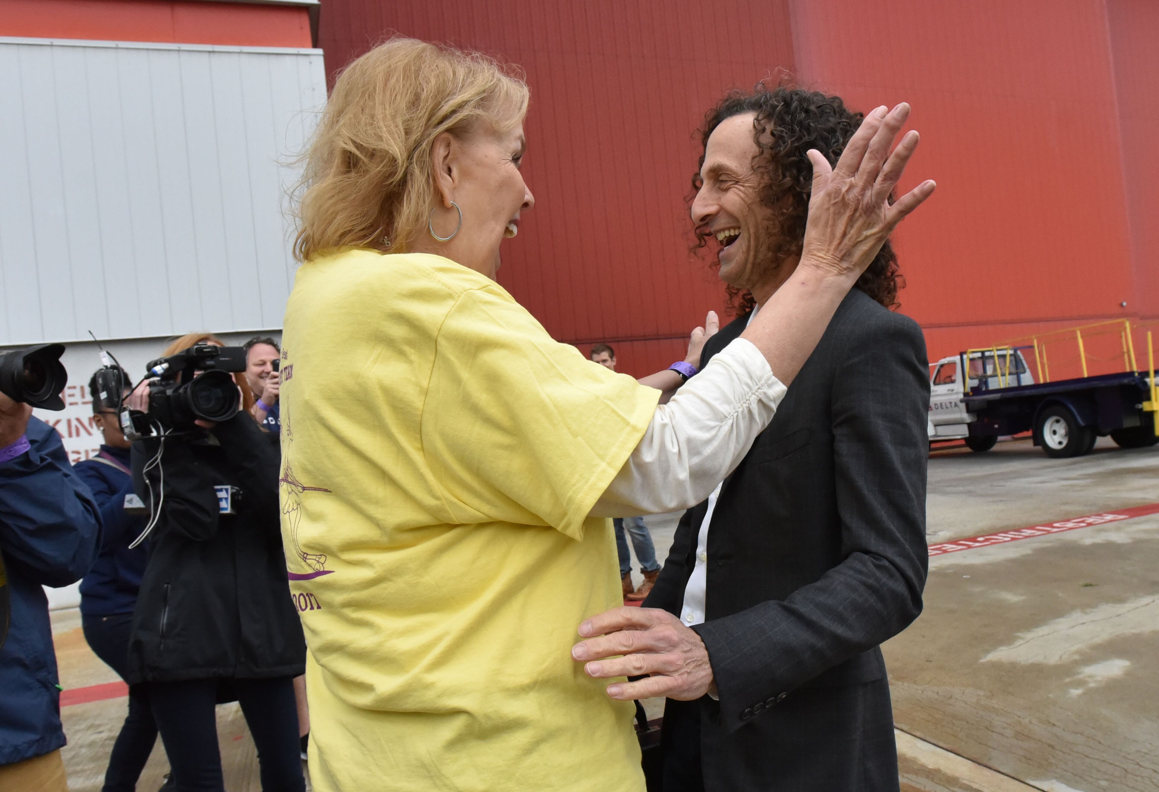 May 5, 2017 Atlanta - Kenny G arrives and surprises Delta flight attendant Jane Mitchell, who inspired Kenny to play on the flight, during the 8th annual Jet Drag on Friday, May 5, 2017. Teams, of no more than 20 people are timed as they compete for prizes as they pull a 167,000-pound pound Boeing 757 aircraft for about 20 feet. When the Delta Jet Drag began eight years ago, Robert Cisneros signed up to pull that 167,000 pound plane. At first, participating in the fundraiser was just a way to support friends, coworkers and loved ones battling cancer. Then, when his mother was diagnosed, that passion turned into something more. HYOSUB SHIN / HSHIN@AJC.COM