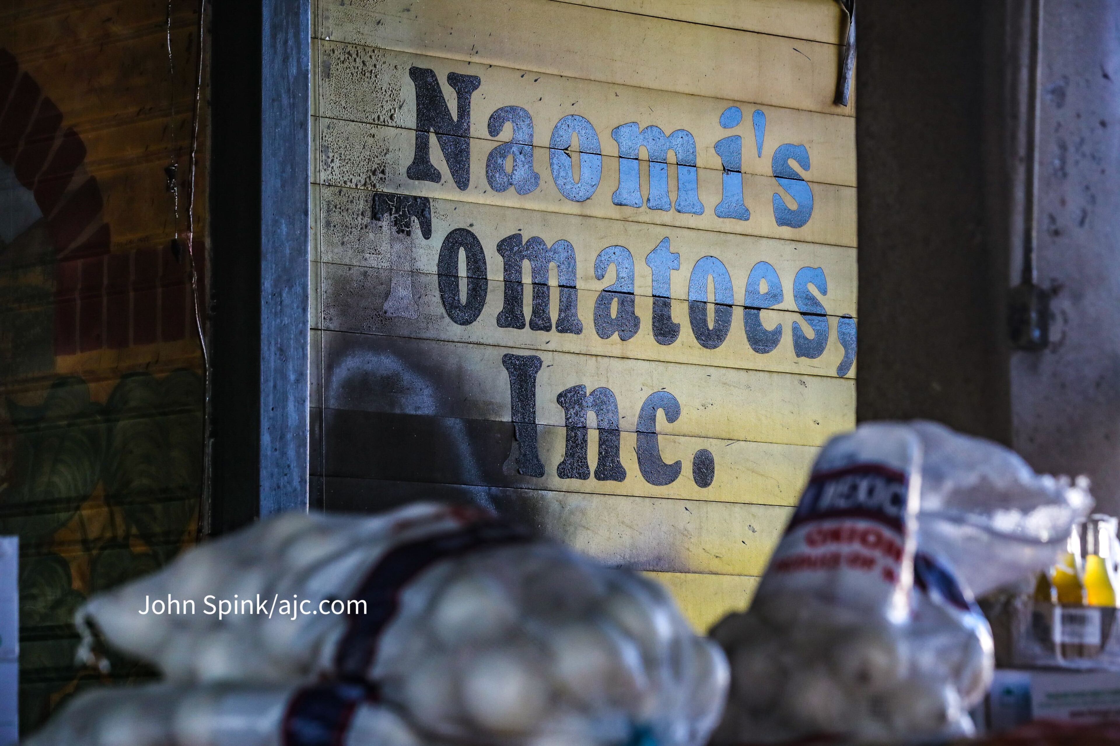 By Wednesday morning, Naomi's Tomatoes had been cleaned out and all that remained of the produce stand was a burned-out shell. Oct. 18, 2023 (Credit: John Spink / john.spink@ajc.com)