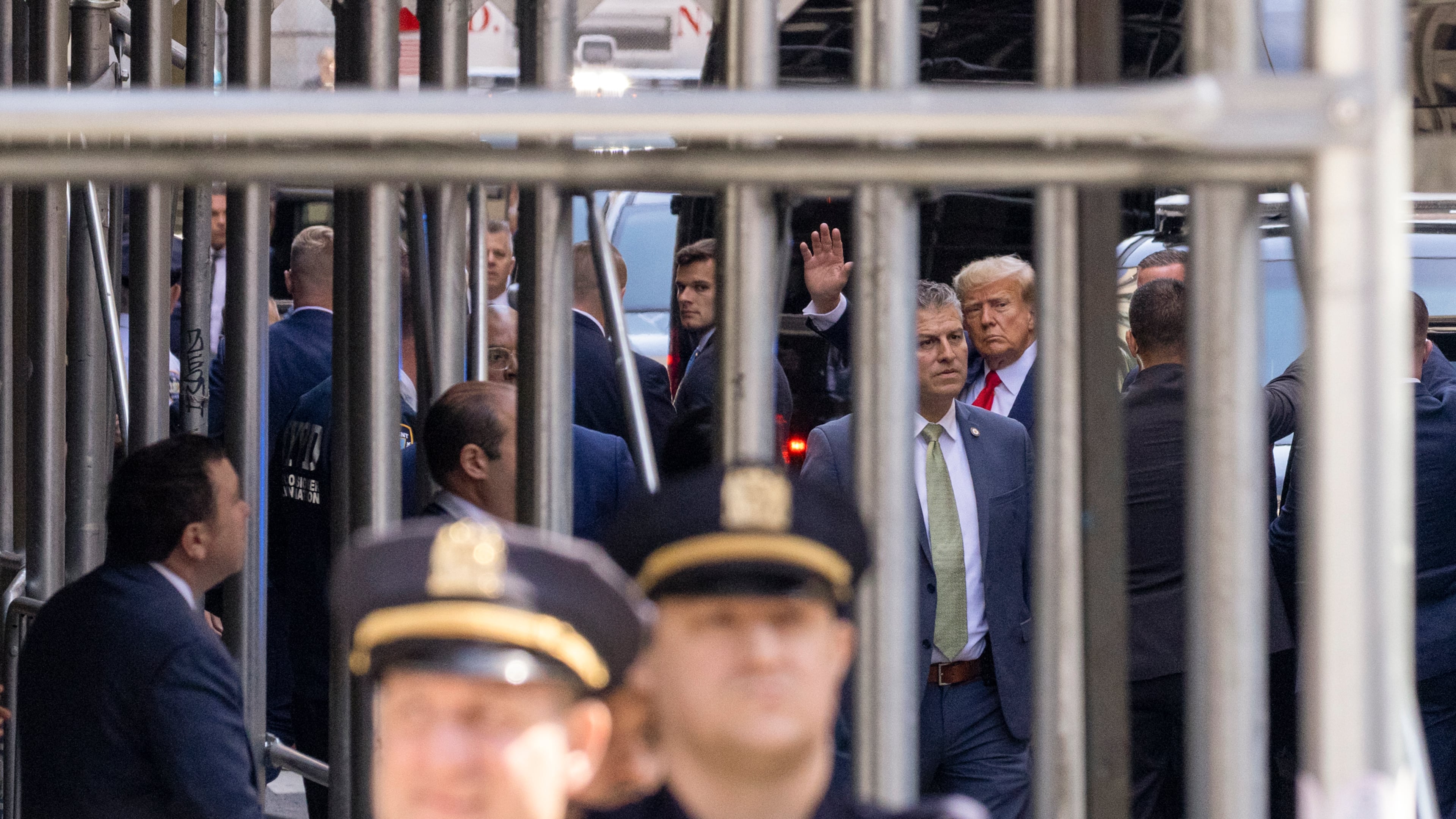 Former President Donald Trump waves as he arrives at the Manhattan Criminal Courthouse in Manhattan, April 4, 2023. The former president is expected to appear today in a Manhattan courtroom and plead not guilty to charges related to his role in a hush-money payment to a porn star in the last days of the 2016 presidential campaign. (Benjamin Norman/The New York Times)