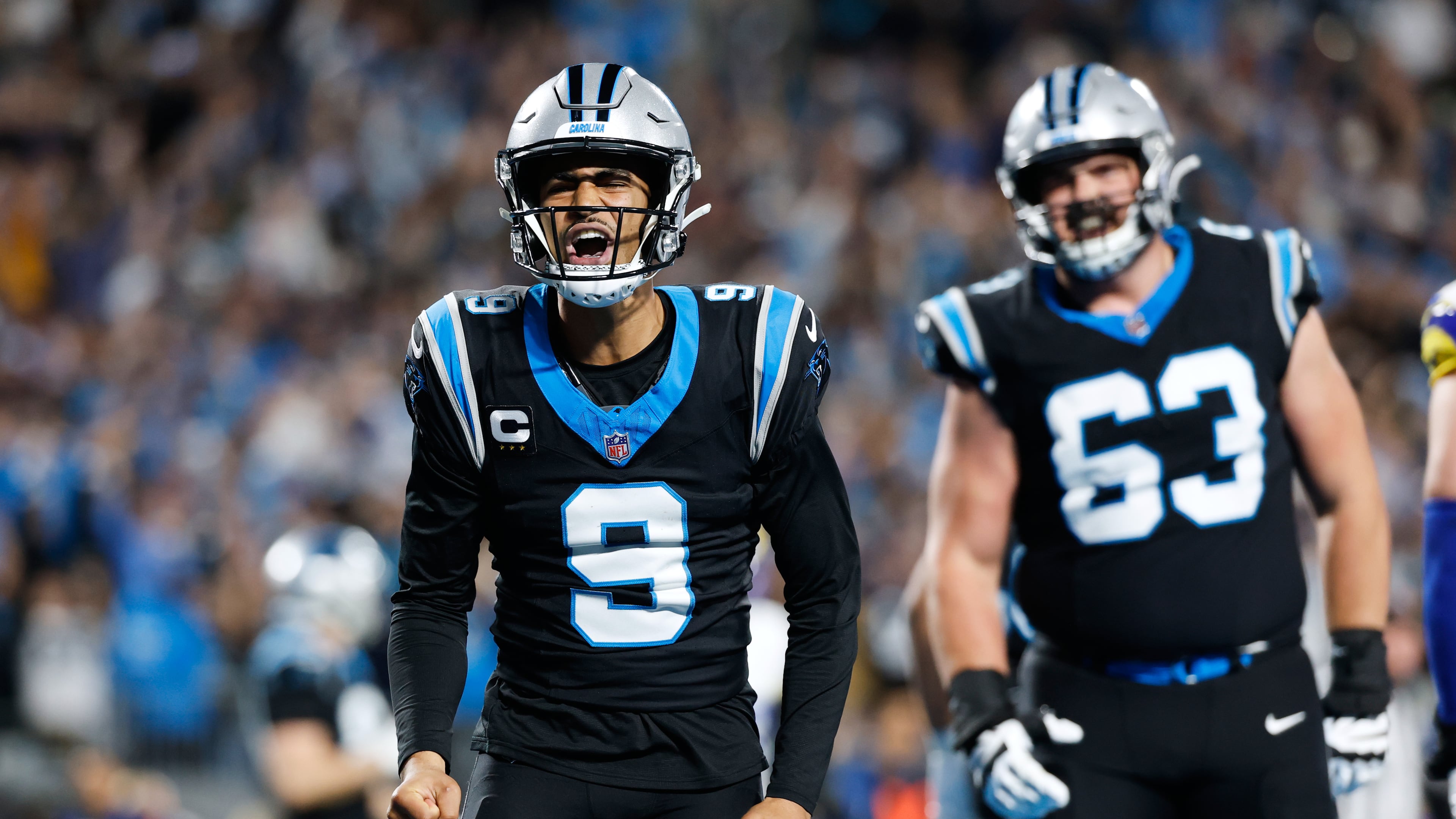 Carolina Panthers quarterback Bryce Young (9) celebrates after scoring a touchdown during the first half of an NFL wild-card playoff football game against the Los Angeles Rams, Saturday, Jan. 10, 2026, in Charlotte, N.C. (AP Photo/Rusty Jones)