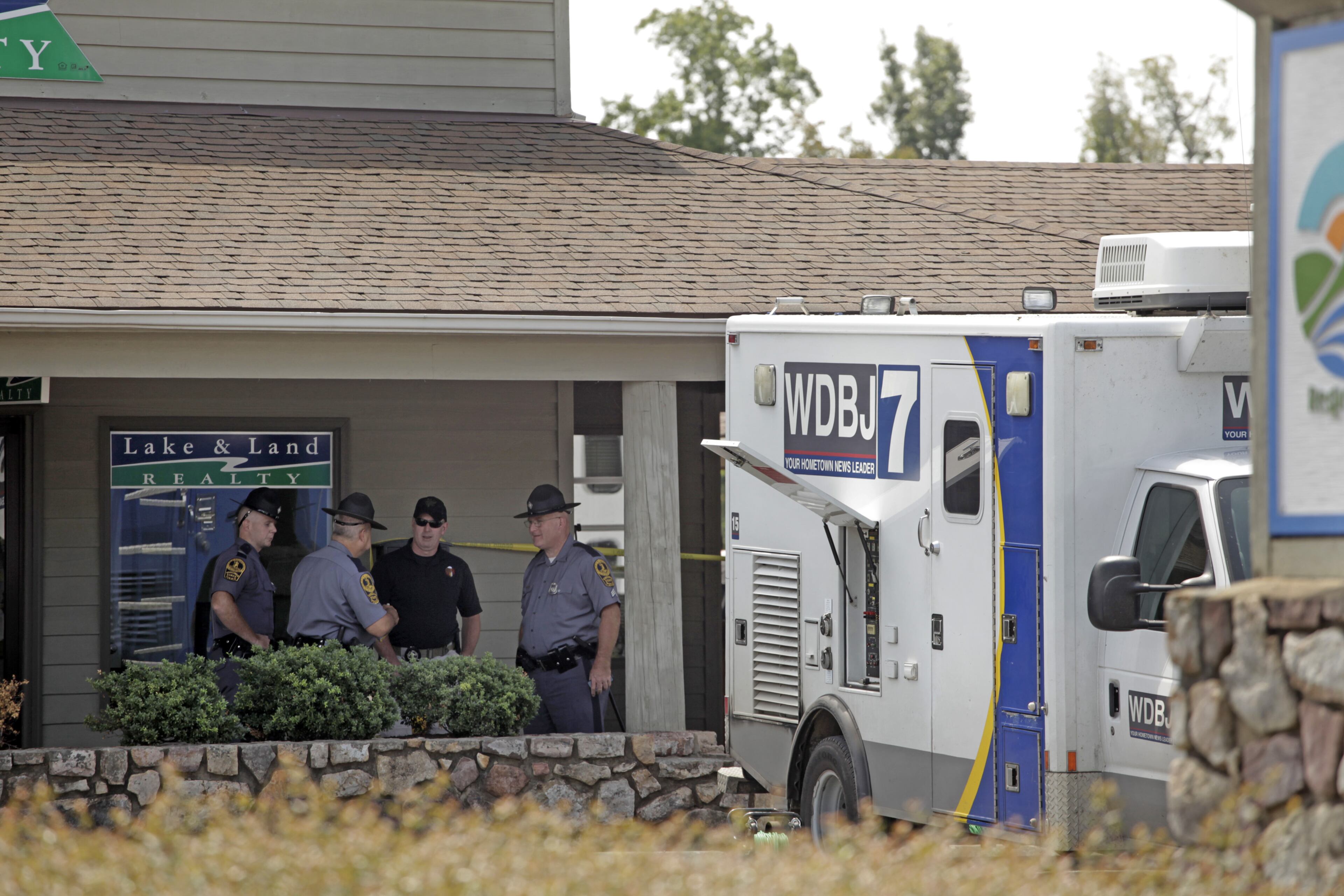 Police work the crime scene at Bridgewater Plaza on Smith Mountain Lake on August 26, 2015, in Moneta, Virginia. A WDBJ-TV truck is seen at right.
