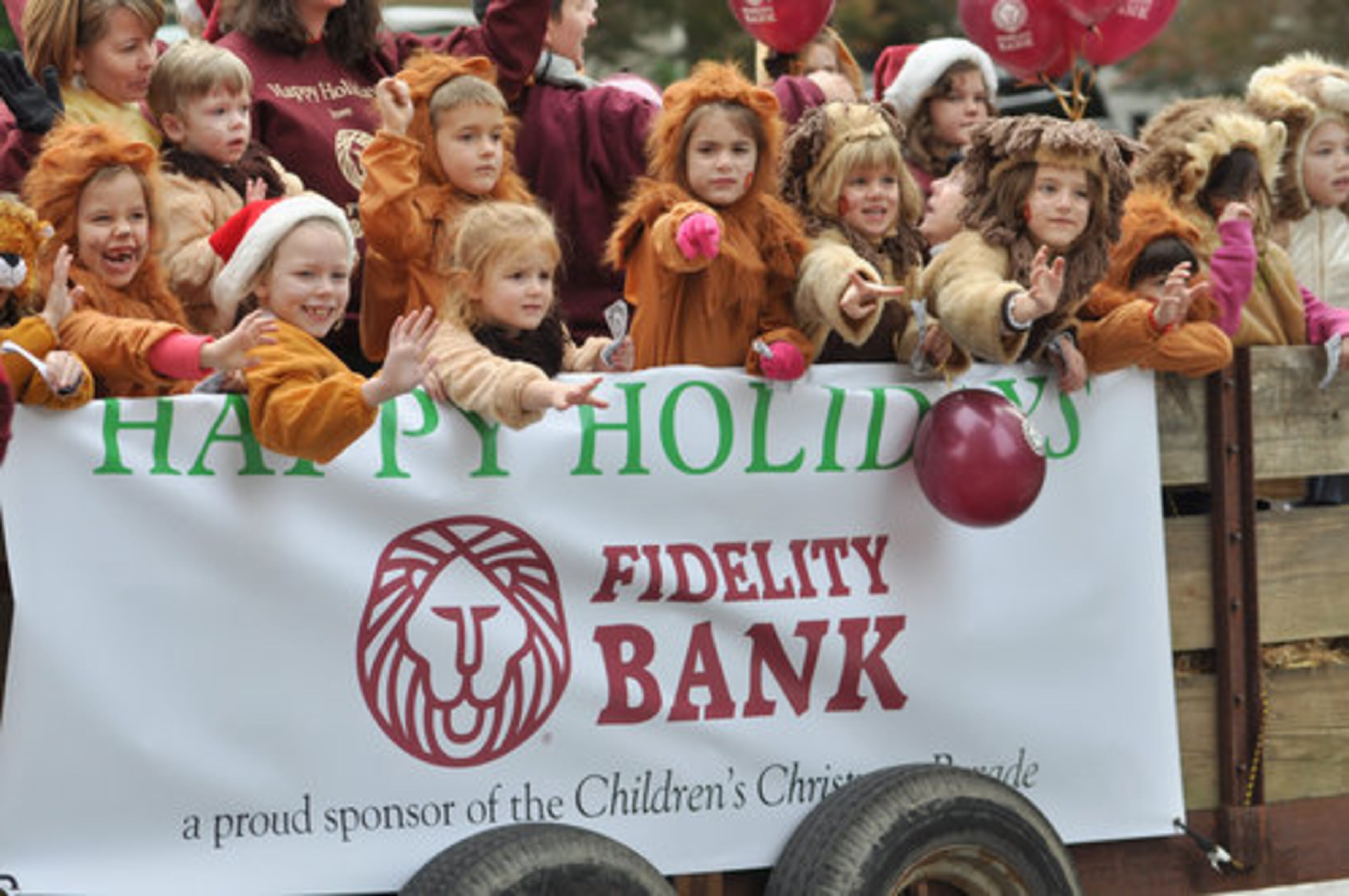 HOLIDAY ON PARADE-- Young well wishers wave to the crowd during the Childrens Healthcare parade in Downtown Atlanta, Georgia Saturday, Dec. 5, 2010.