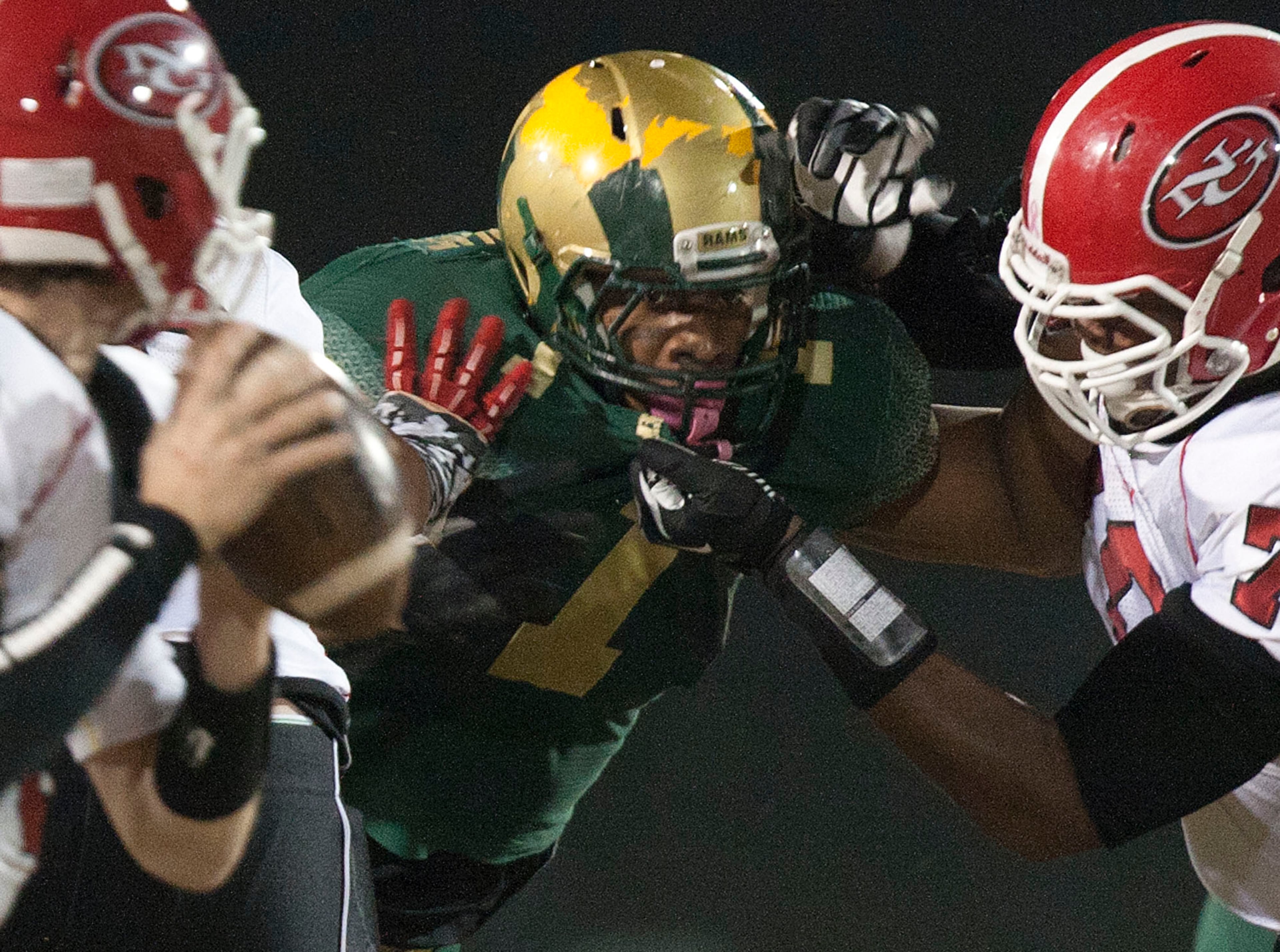 Grayson defensive end Robert Nkemdiche eyes the North Gwinnett quarterback.