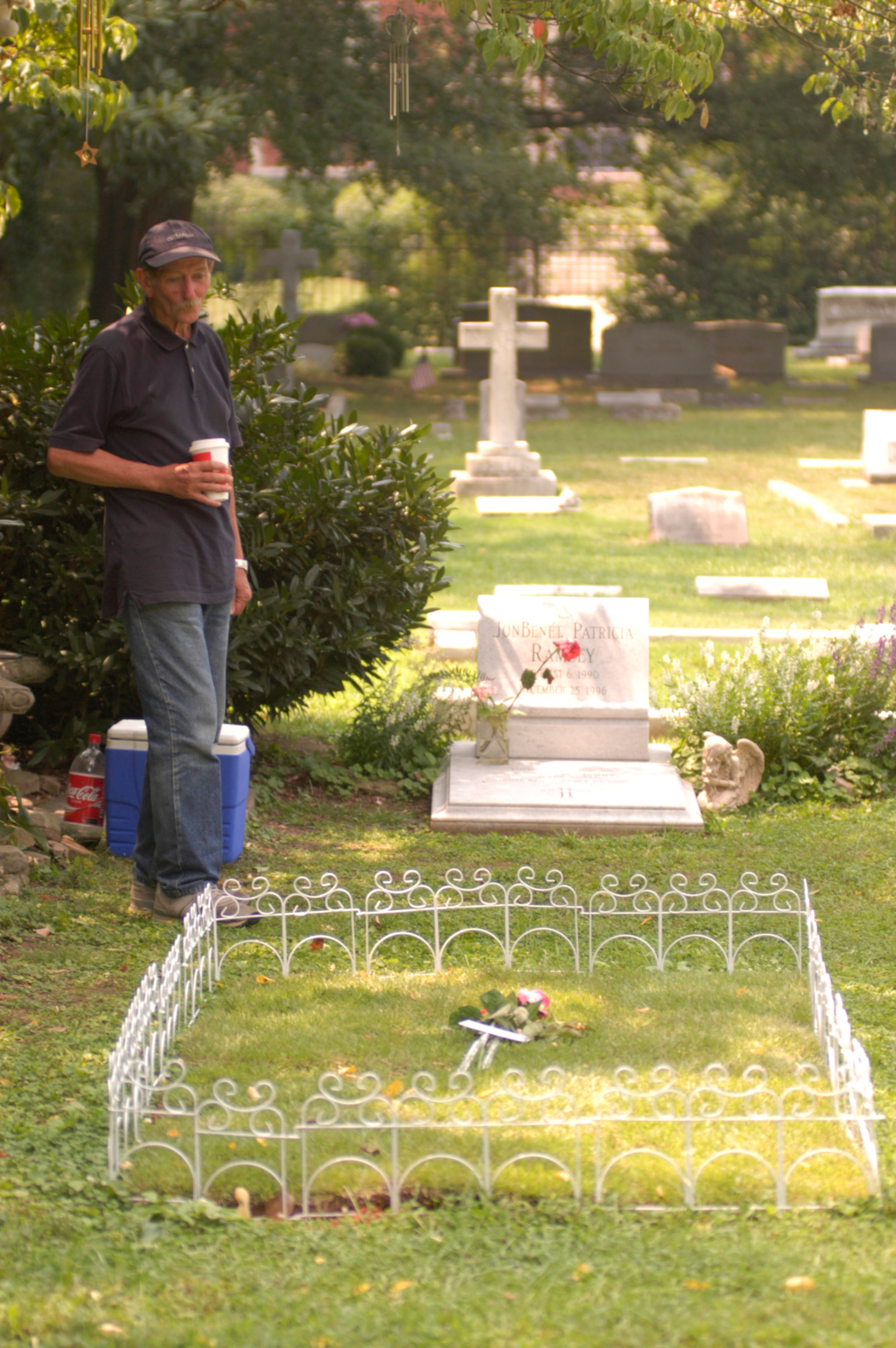 A man visits the grave sites of JonBenet and Patsy Ramsey at St. James Cemetery in Marietta. Patsy Ramsey died of cancer in 2006, at the age of 49. She was buried next to her daughter.