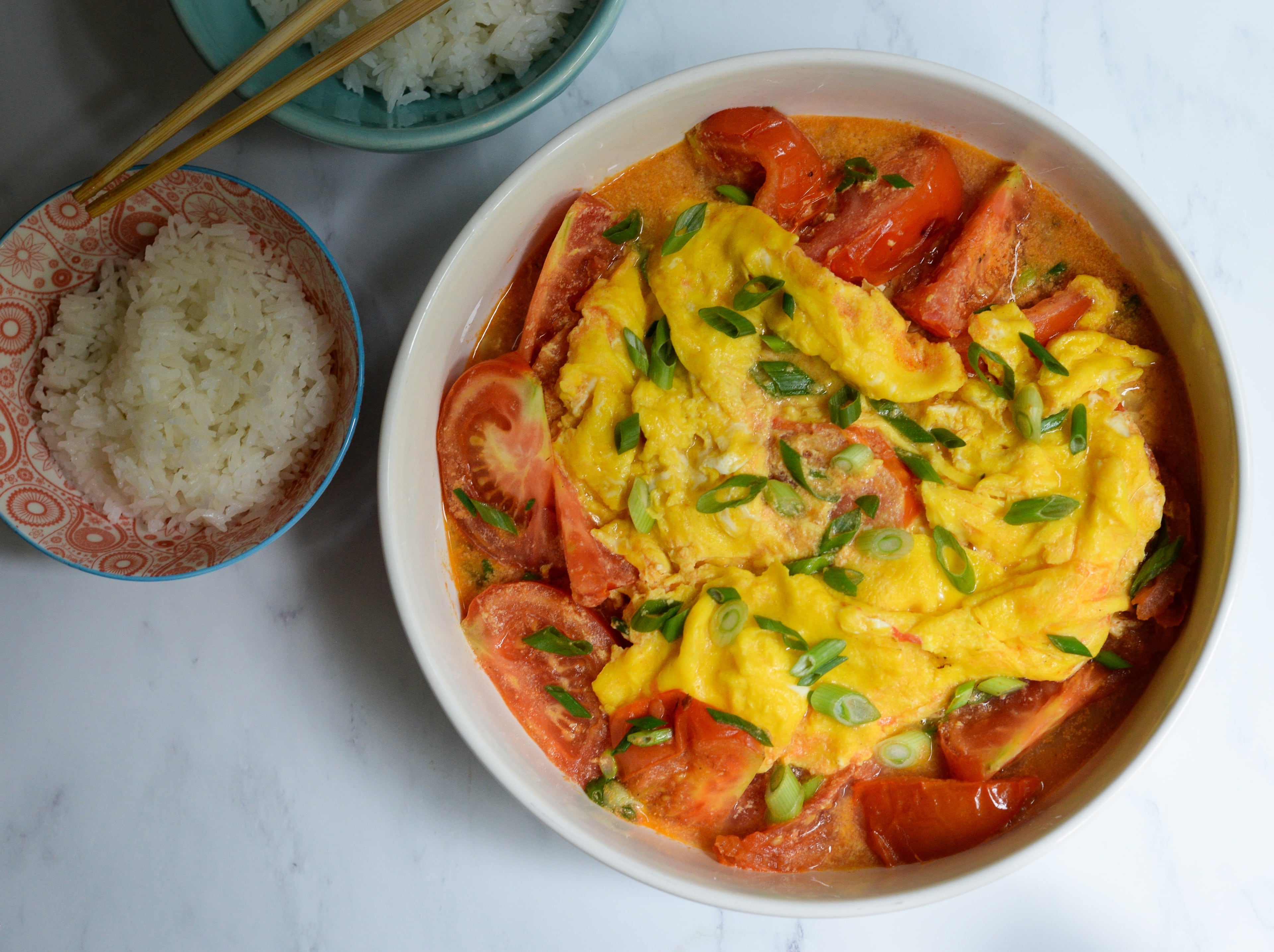 Garnish your Tomato and Egg Stir-Fry with chopped scallions and serve with steamed white rice. (Candy Hom for the AJC)