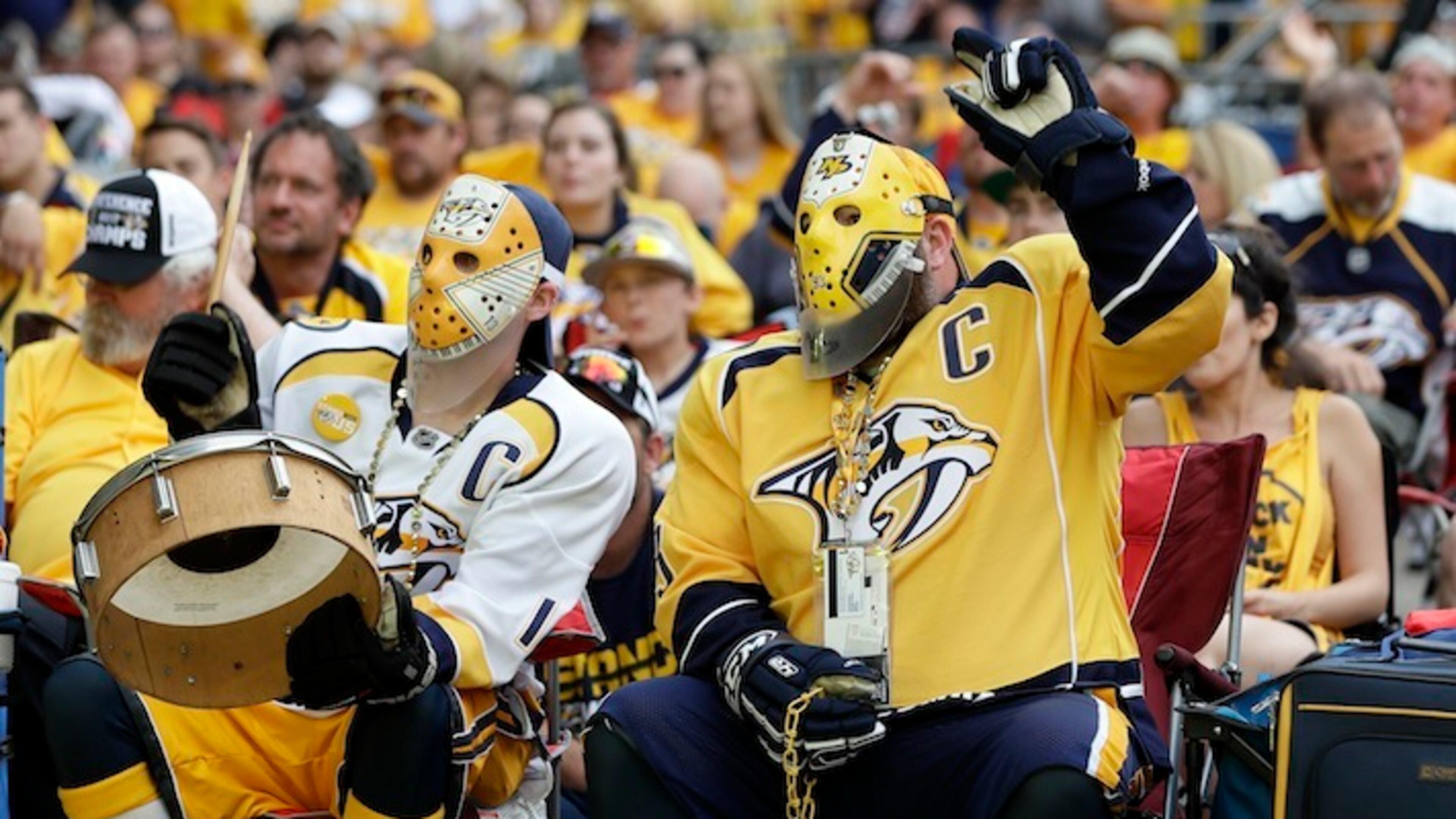 Nashville Predators fans Scott Sulfridge, left, and Chris Rickman, right, cheer as they watch the Predators play the Pittsburgh Penguins in Game 1 of the NHL Stanley Cup Finals at one of several viewing areas set up Monday, May 29, 2017, in Nashville, Tenn. (AP Photo/Mark Humphrey)