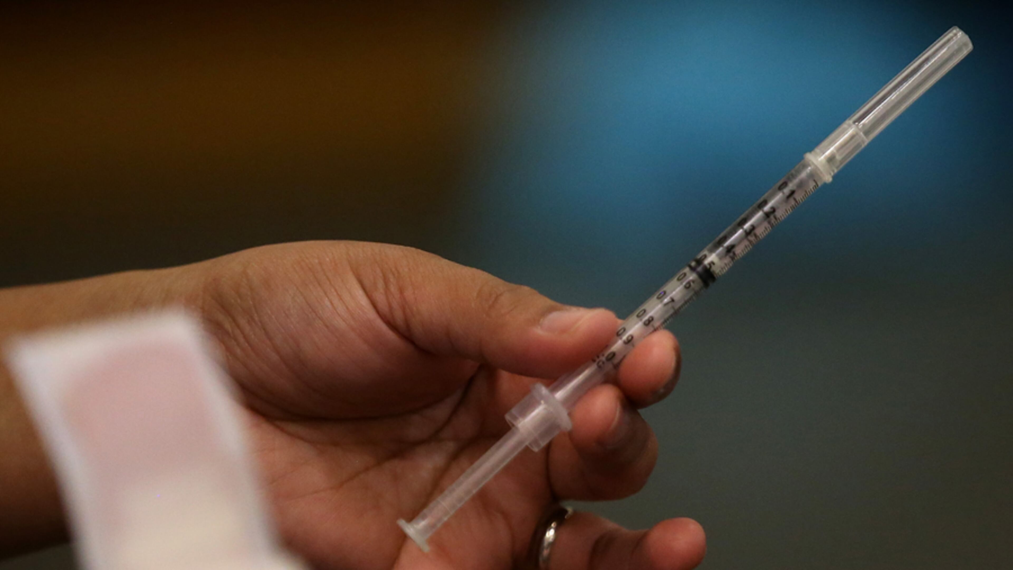 OAKLAND, CA - DECEMBER 19: A Walgreens employee holds a syringe during a free flu shot clinic at Allen Temple Baptist Church on December 19, 2014 in Oakland, California. Oakland residents received no cost flu shots during a flu shot clinic at Allen Temple Baptist Church. (Photo by Justin Sullivan/Getty Images)