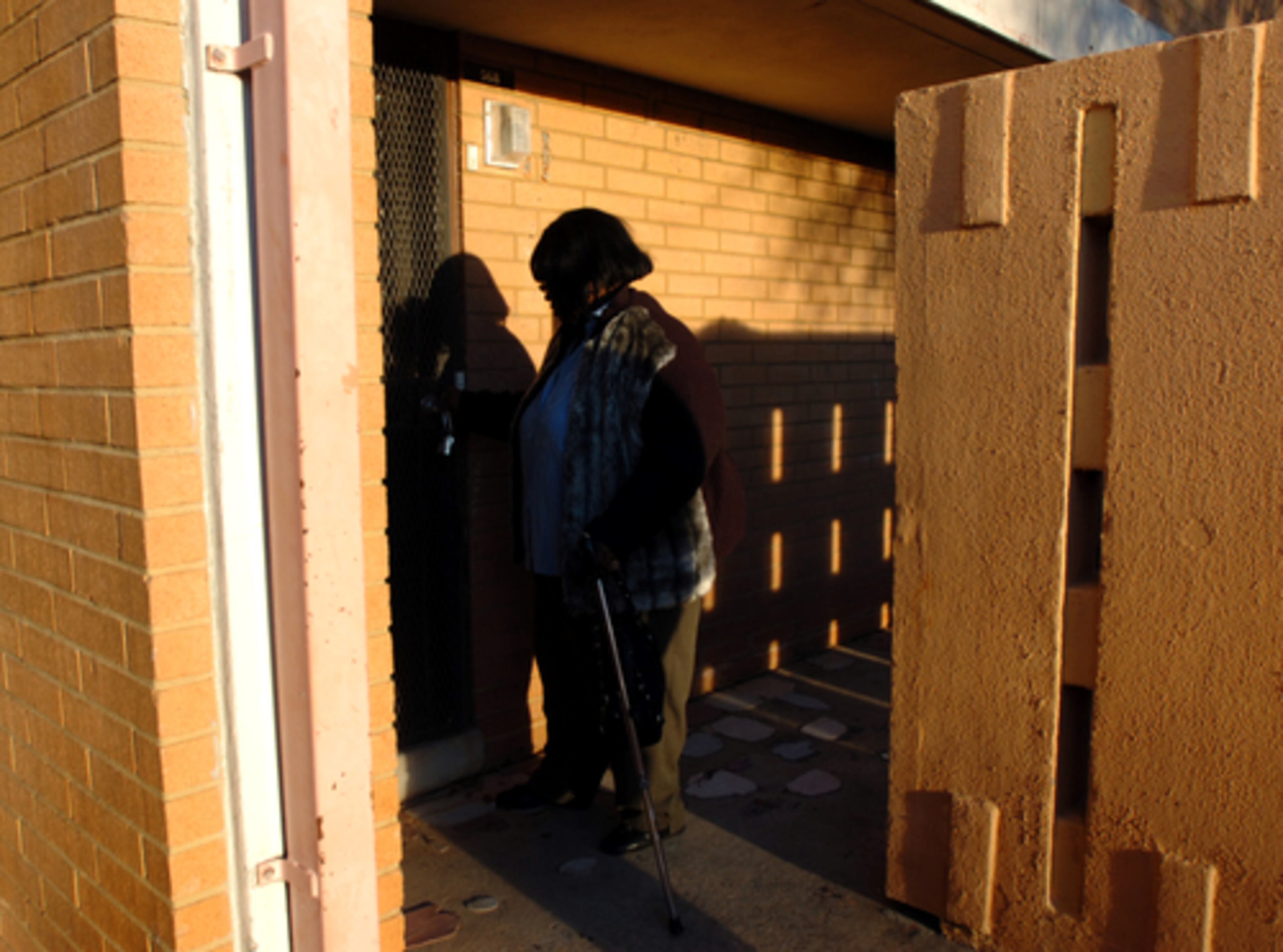 Shirley Hightower locks a door as she leaves. The project, which is home to 1,824 people in 650 units, is located in northwest Atlanta off Donald Lee Hollowell Parkway. An elementary school and library are also on the property.