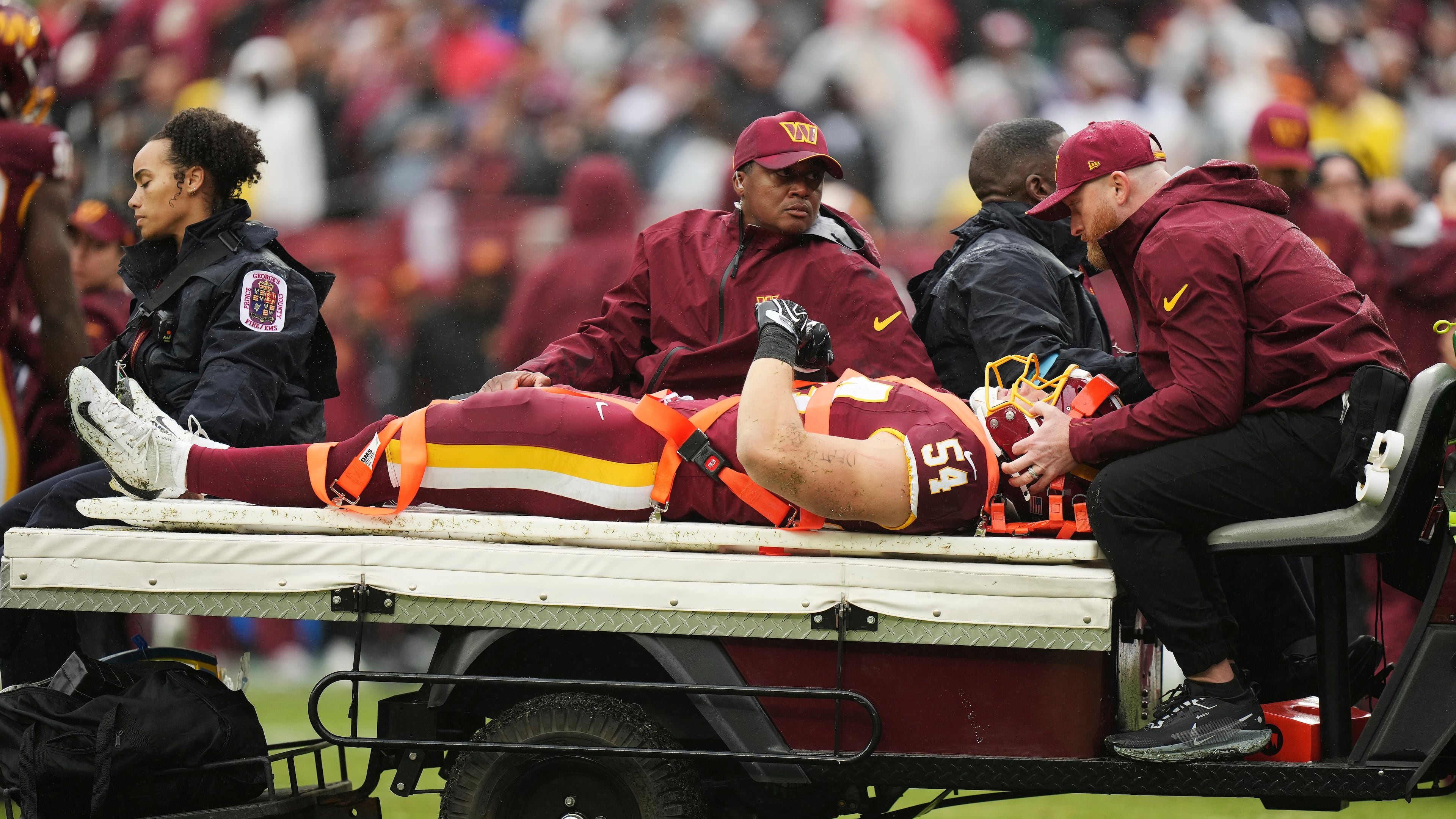 Washington Commanders linebacker Leo Chenal (54) is transported off the field by the medical team during the first half of an NFL football game against the Seattle Seahawks, Sunday, Sept. 27, 2026 in Landover, Md. (AP Photo/Stephanie Scarbrough)