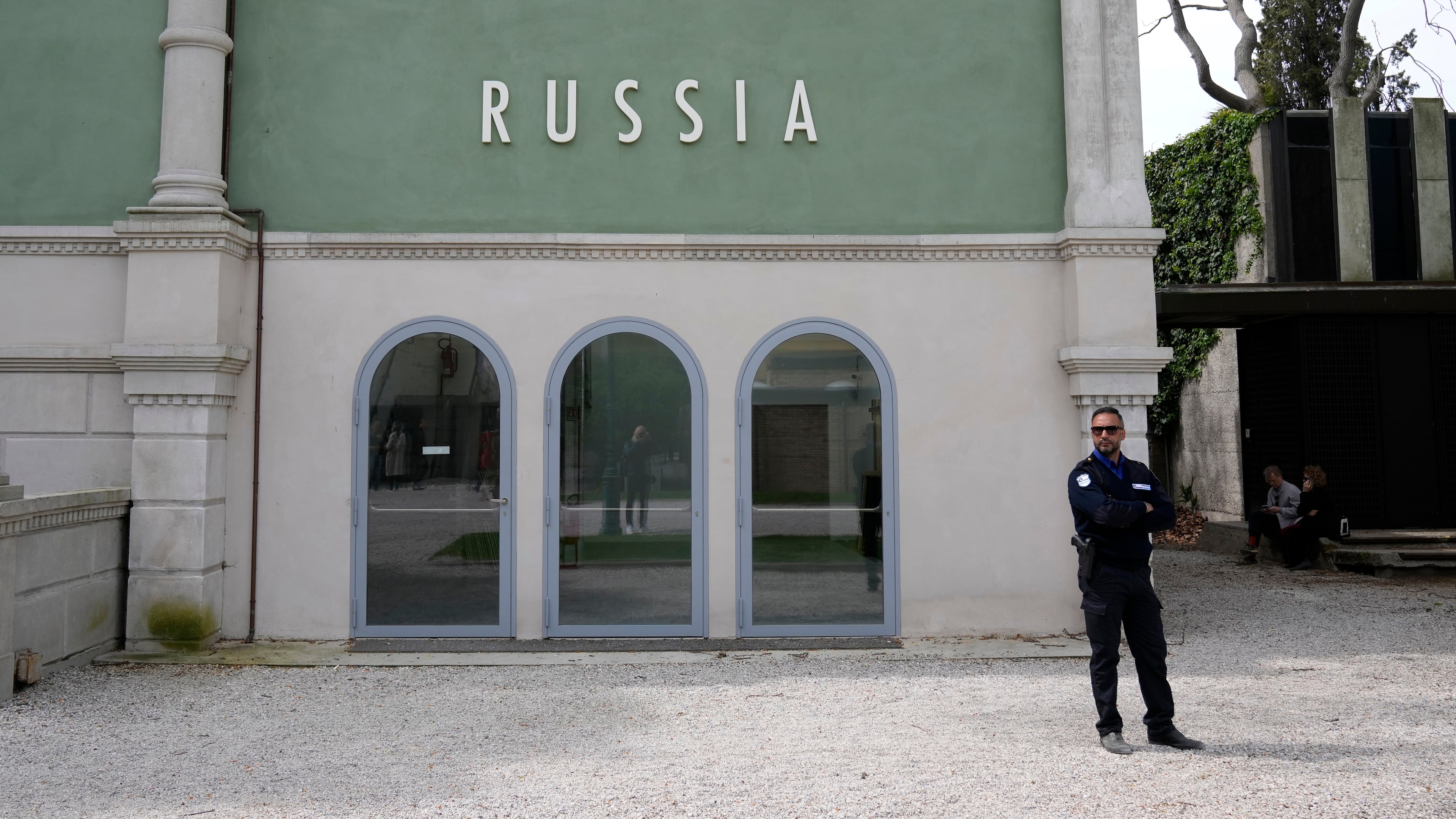 FILE - A private security officer stands next to a closed Russia's pavilion at the 59th Biennale of Arts exhibition in Venice, Italy, Tuesday, April 19, 2022. (AP Photo/Antonio Calanni, File)