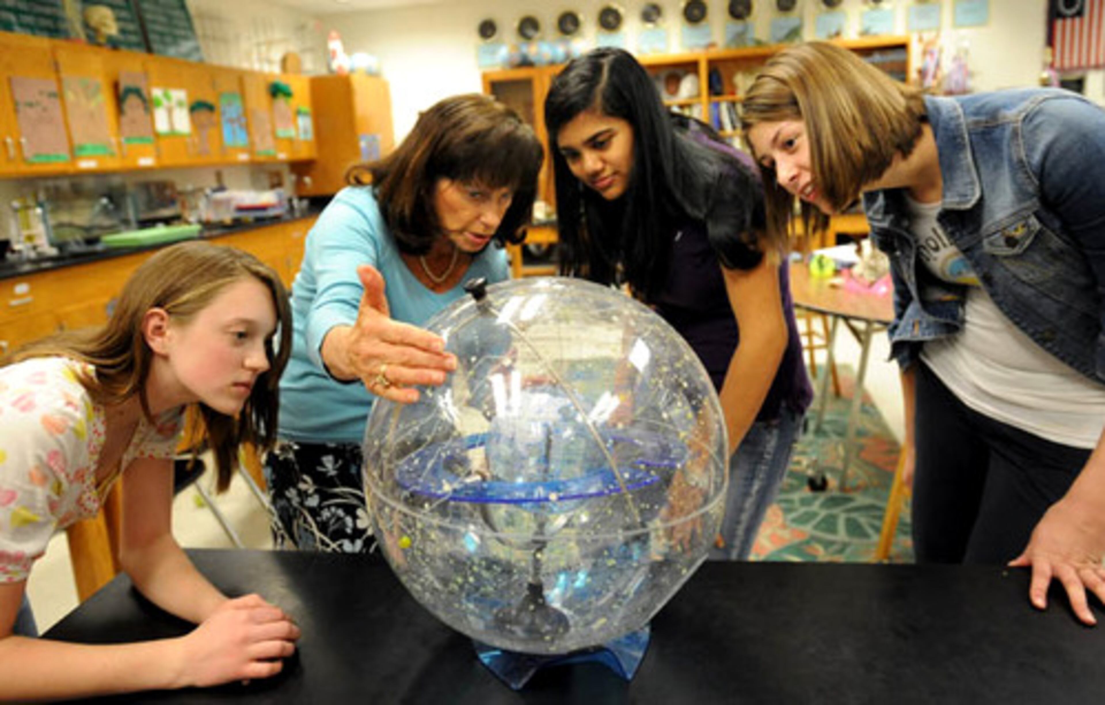 J.C. Booth Middle School in Peachtree City is a Science Olympiad powerhouse and they prepare for the state competition in Washington DC on Saturday. Science Olympiad Coach Mary Wilde (second from left) explains with Celestial Globe to learn constellations and stars as 9th graders (from left) Hannah Chambless, Brahma NaTarajan, and Cara Ludwick look on at J.C. Booth Middle School.