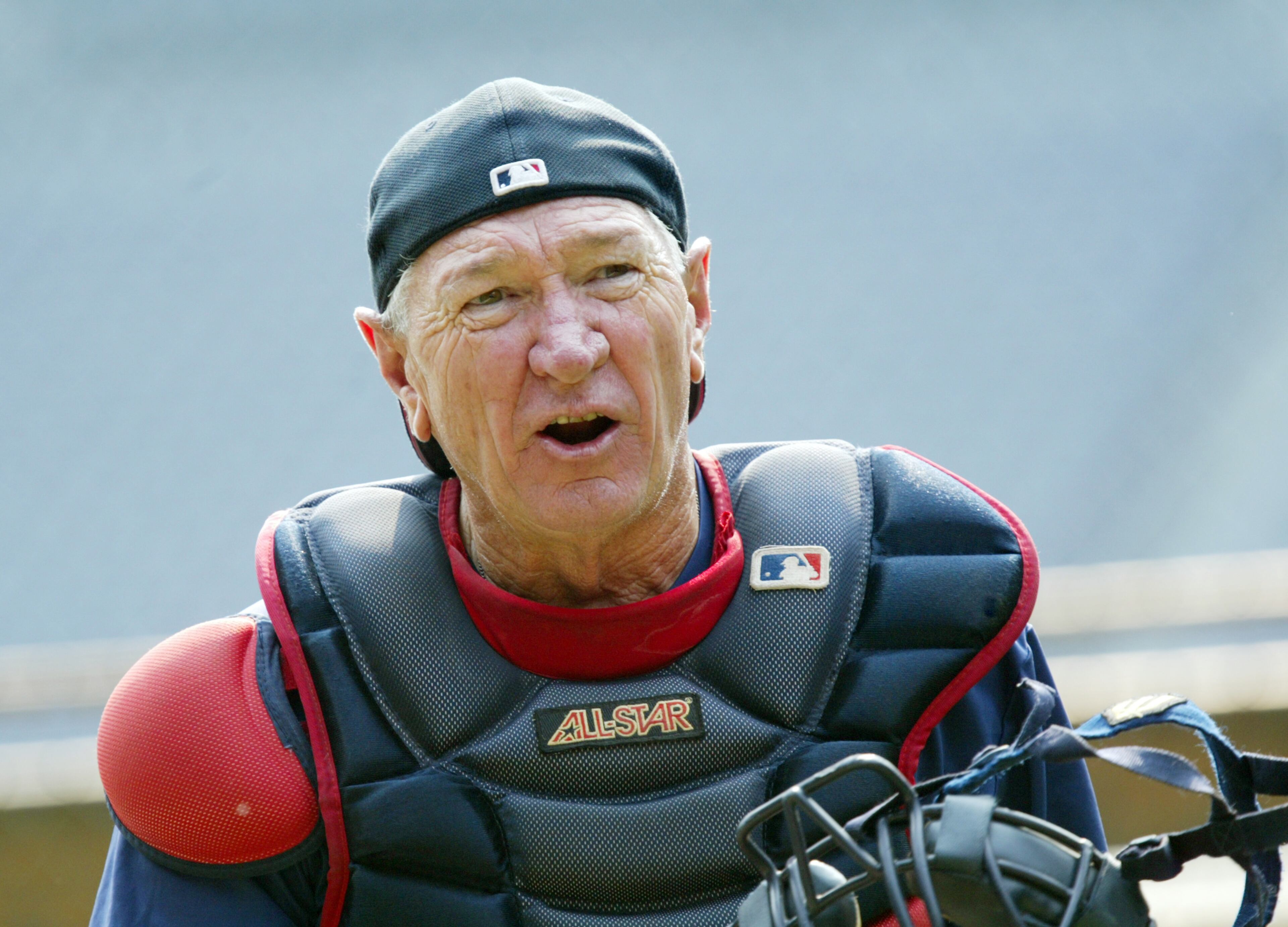 060725 - ATLANTA, GA -- Bobby Dews, 67, a bullpen coach for the Atlanta Braves, catches in the bullpen before the Braves game against the Florida Marlins on Tuesday, July 25, 2006. (JENNI GIRTMAN/AJC staff)