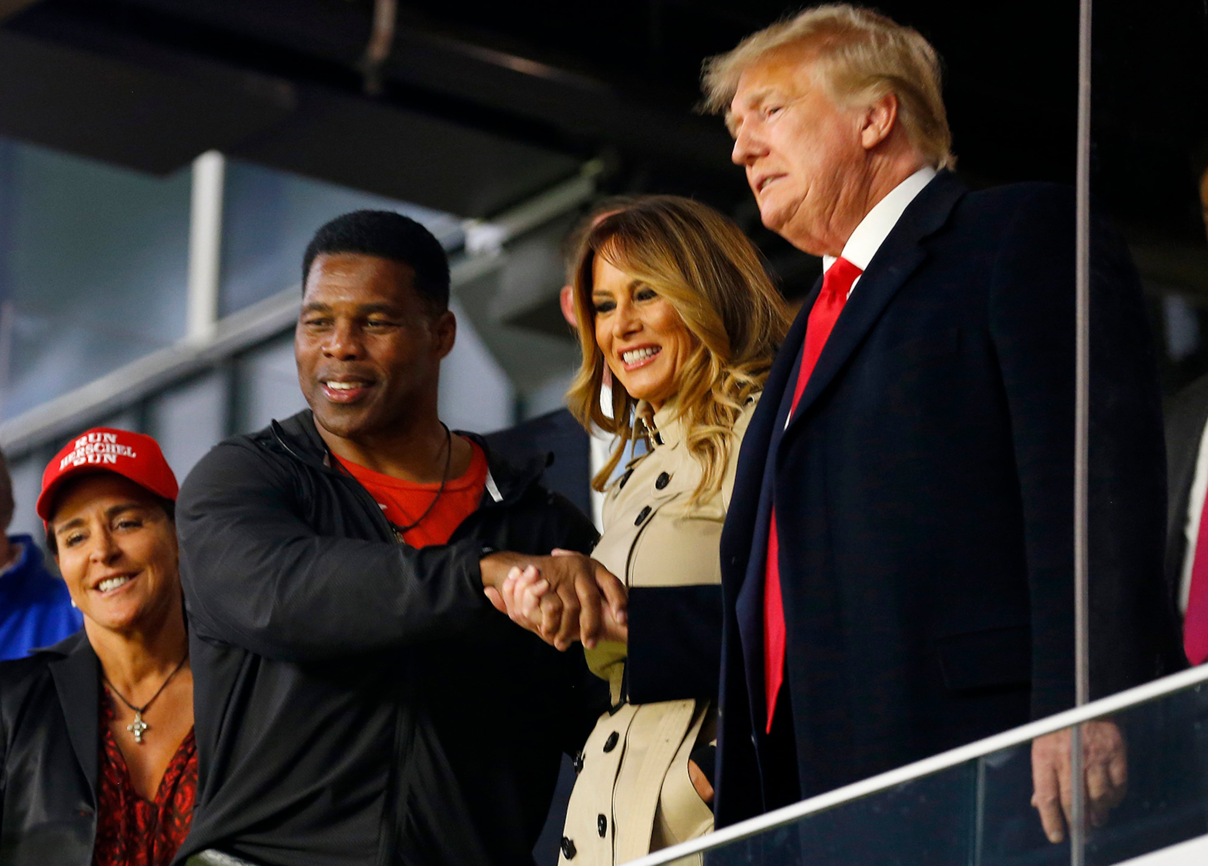 Herschel Walker (second from left) greeted Melania and Donald Trump at an Braves game in Atlanta in 2021.