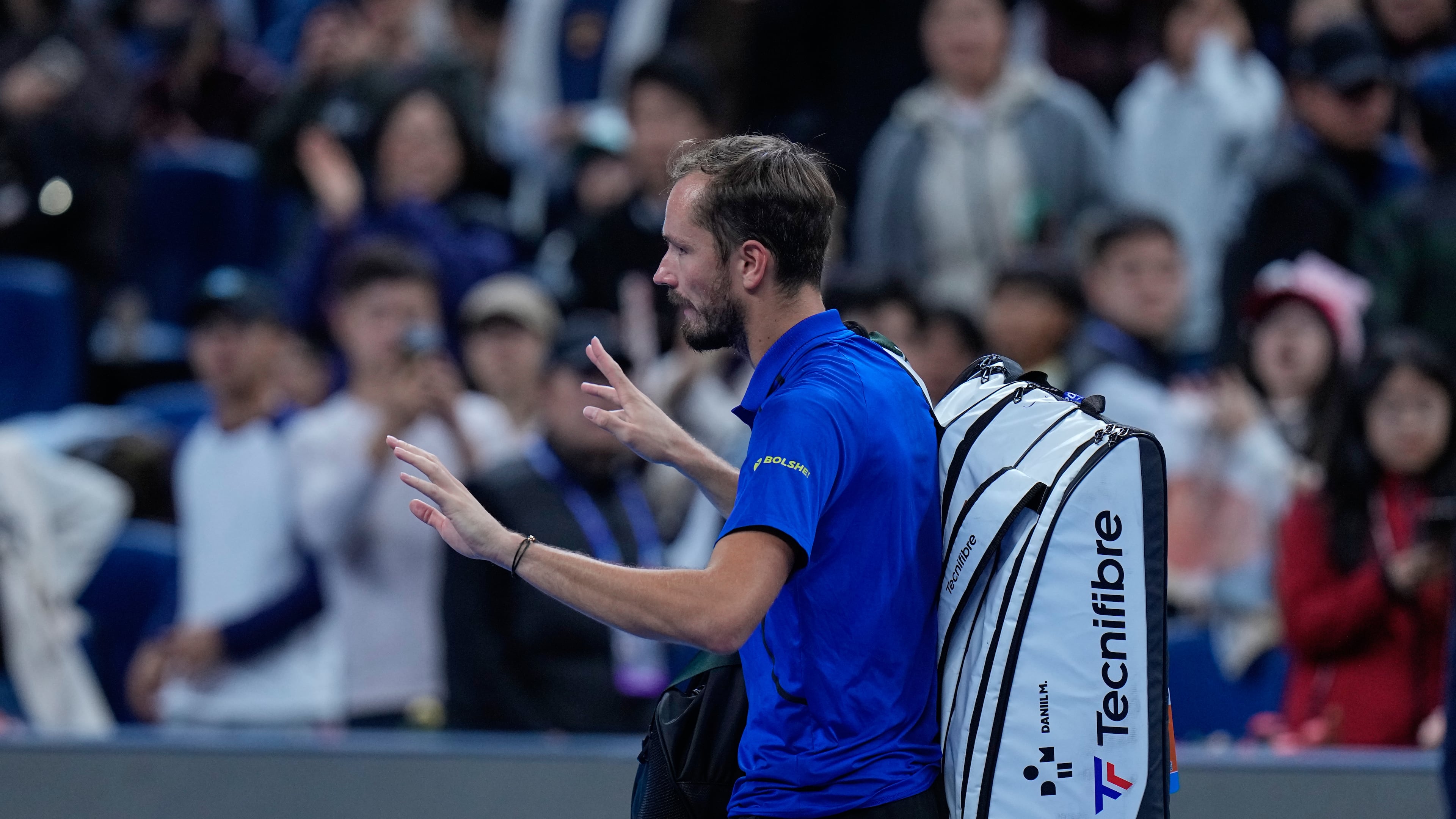 Daniil Medvedev, of Russia, leaves the court after being disqualified during a semi final match against Novak Djokovic, of Serbia at the China Open tennis tournament in Beijing, Monday, Oct. 5, 2026. (AP Photo/Andy Wong)