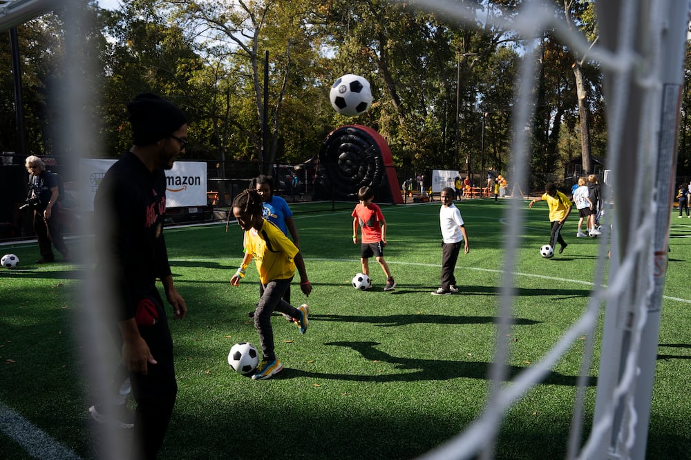 Kids play on the Soccer in the Streets field at the East Lake MARTA station in Atlanta. (Olivia Bowdoin/AJC 2023)