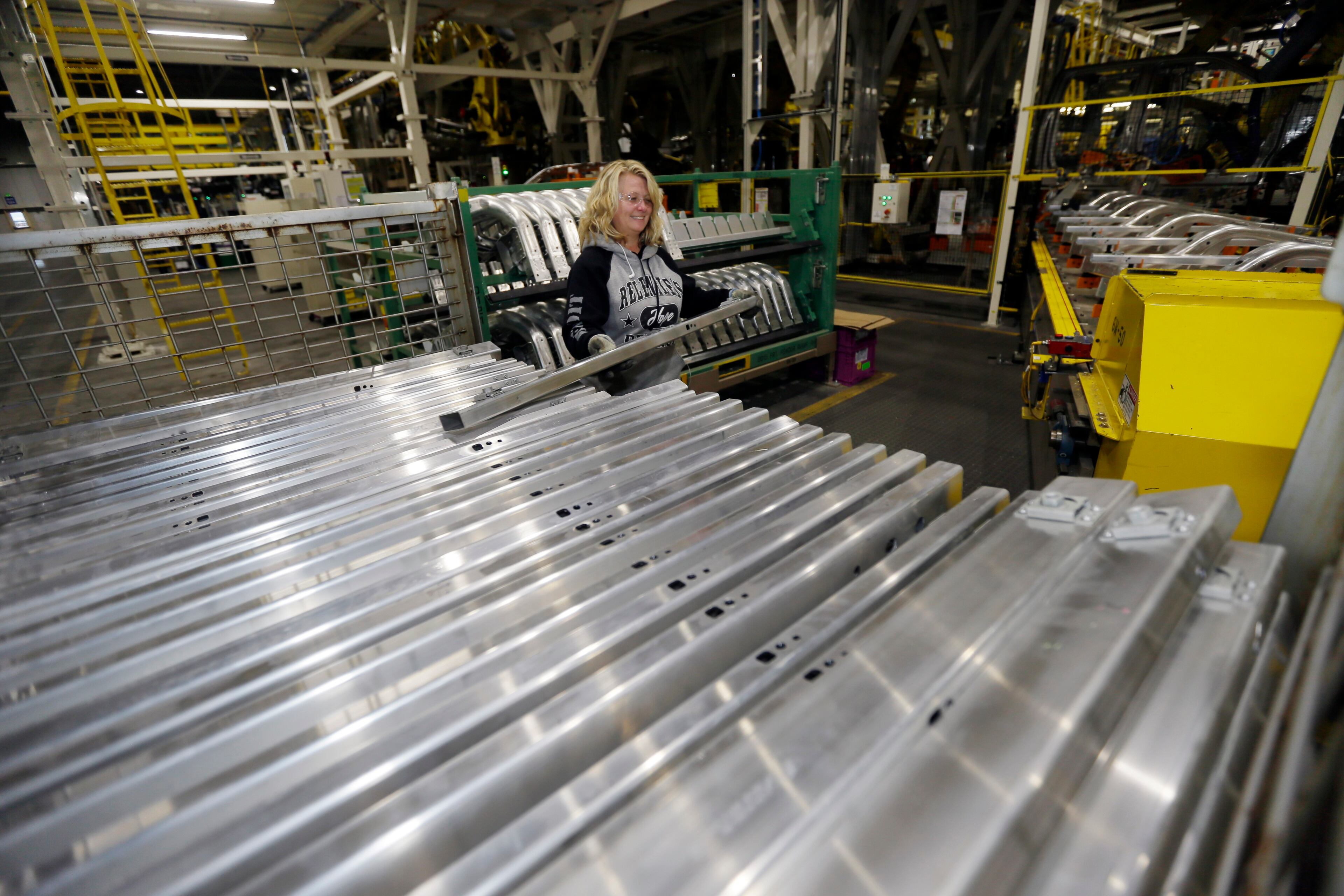 Jennifer Gillesbie works on the frame of the new Ford F-150 truck is assembled at the Rouge Truck Plant in Dearborn, Mich. It's the automaker's biggest bet in decades: an aluminum-sided F-150 that could set a new industry standard _ or cost the company its pickup truck crown. It will arrive on U.S. dealer lots next month. Aluminum _ which is lighter than steel but just as strong _ isn't new to the auto industry, but this is the first time it will cover the entire body of such a high-volume vehicle. (AP Photo/Carlos Osorio)