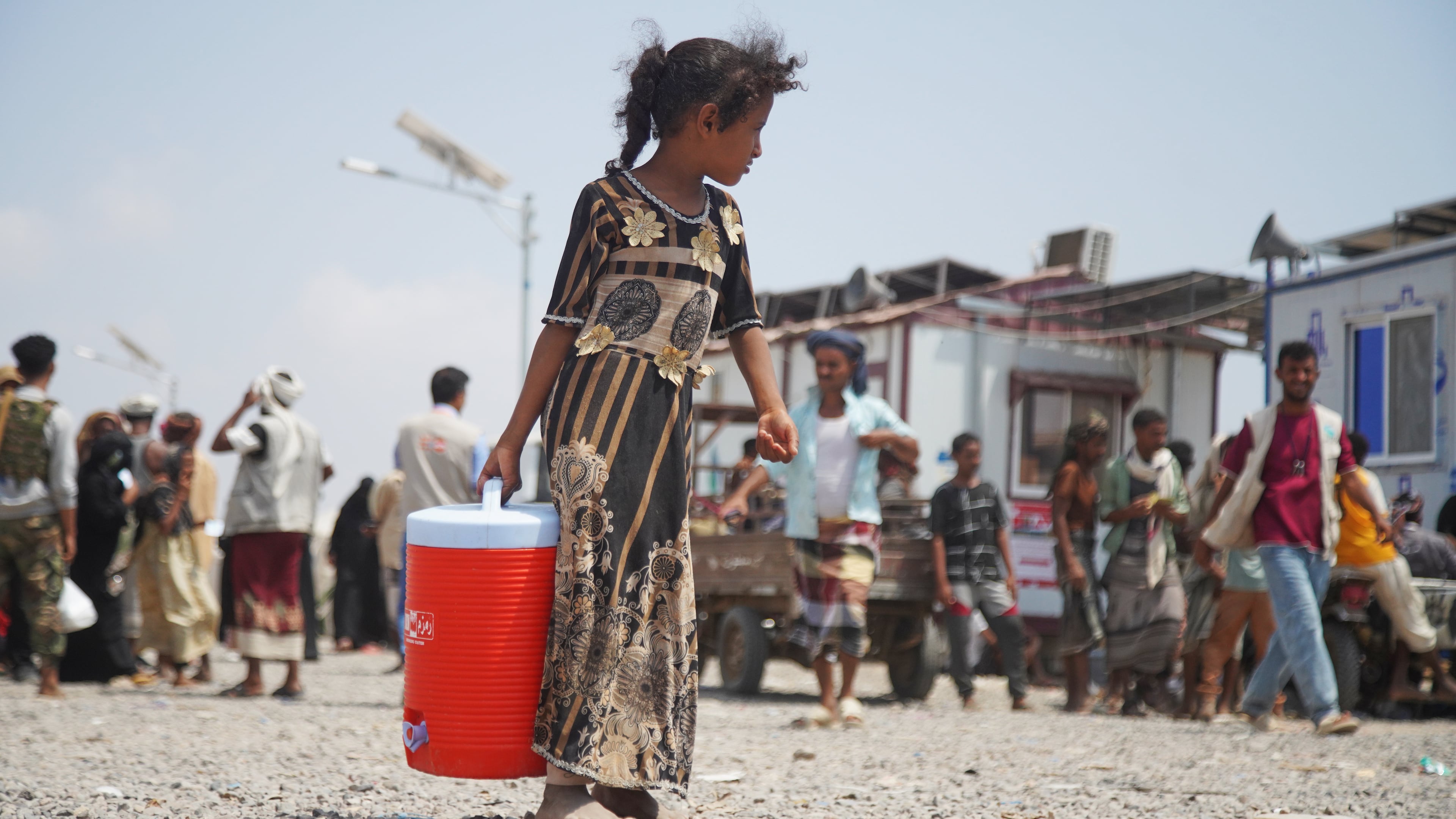 A displaced Yemeni girl walks at Al-Firdaws 2 camp in Ras Imran, on the western outskirts of Aden, Yemen, Yemen, Tuesday, Oct. 20, 2026. (AP Photo/Abdulnasser Alseddik)