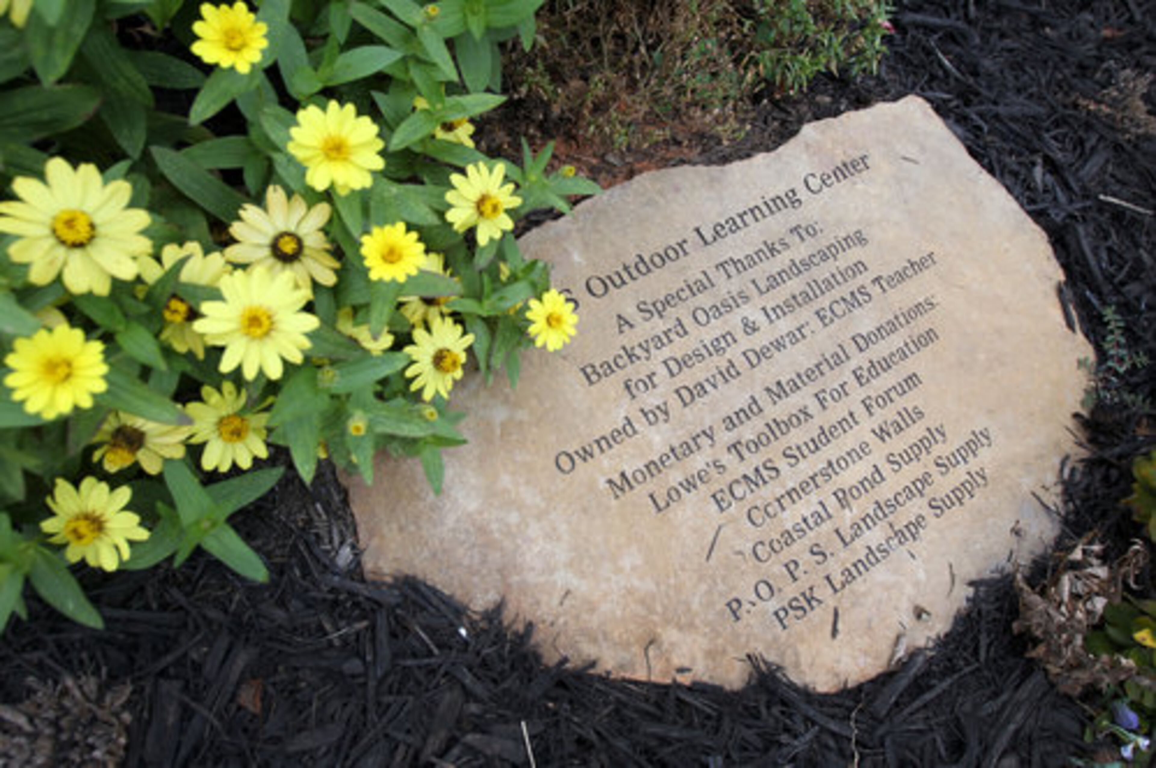 A plaque in the courtyard acknowledges the contributions of those who worked on the project.