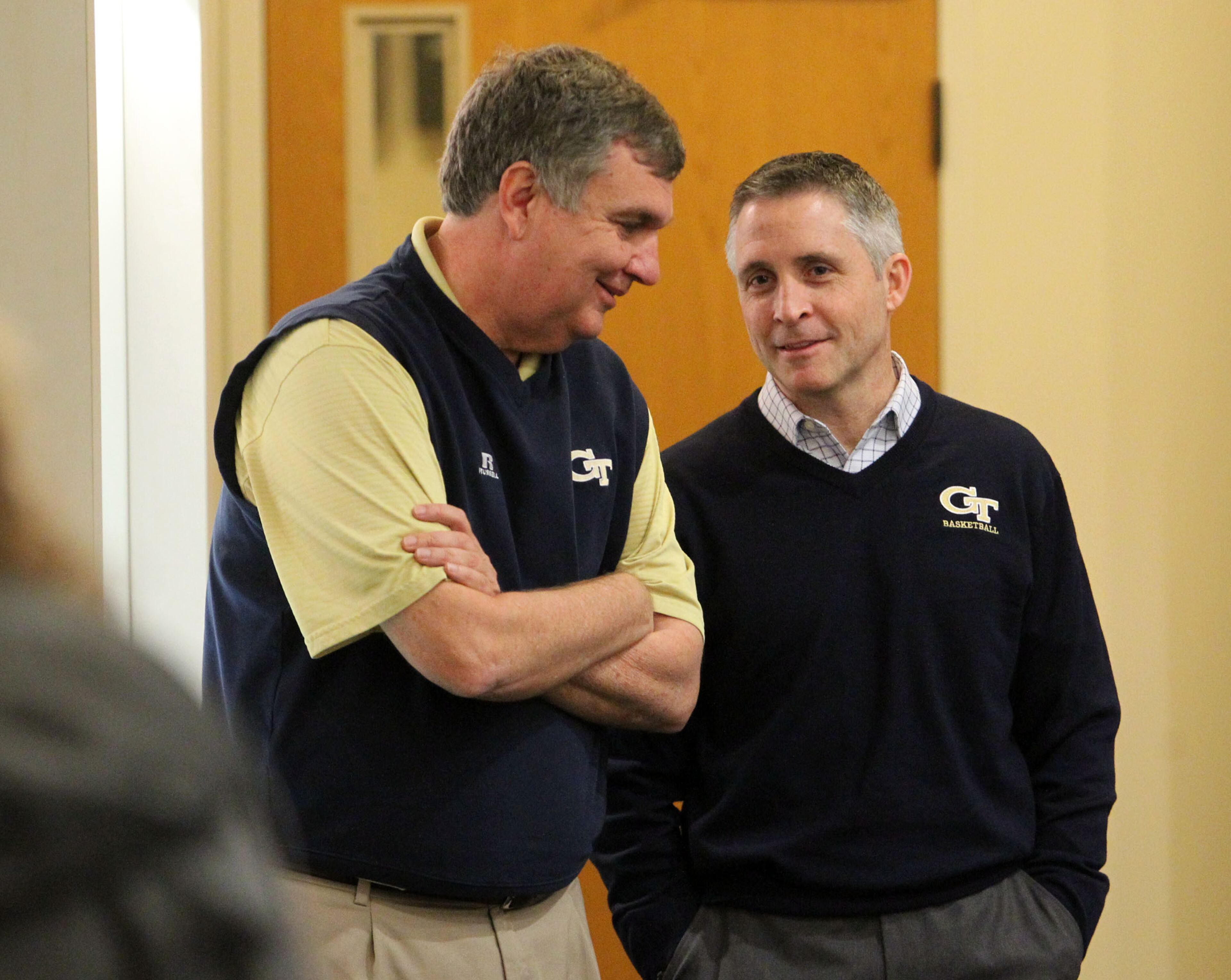 Gregory (right) chats with Tech football coach Paul Johnson.