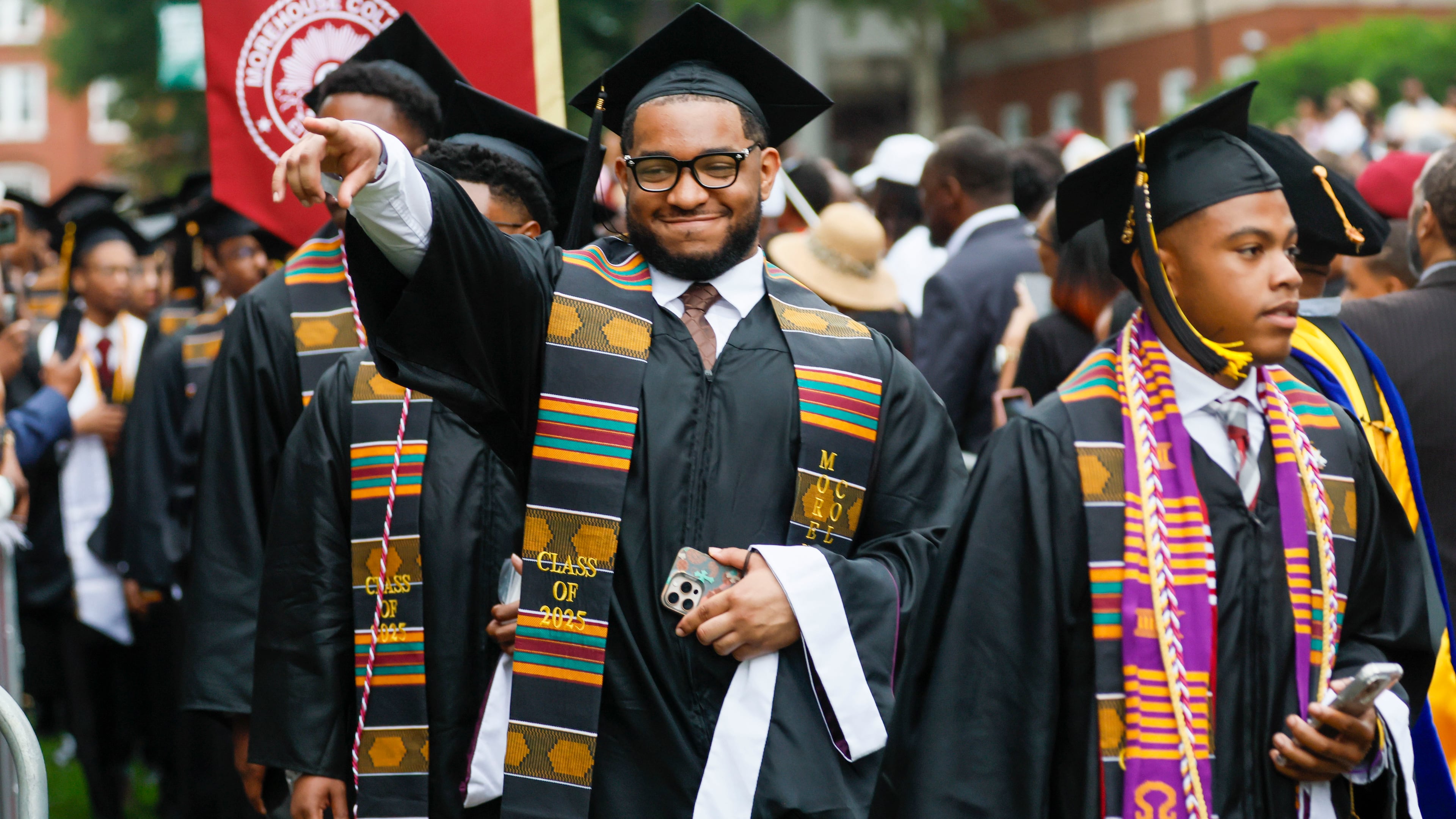 A graduate reacts to family members as he enters the ceremony during Morehouse College's 141st Commencement Ceremony on Sunday, May 18, 2025. The school has seen a spike in interest in recent years, receiving a record-high number of applications.
(Miguel Martinez/ AJC)